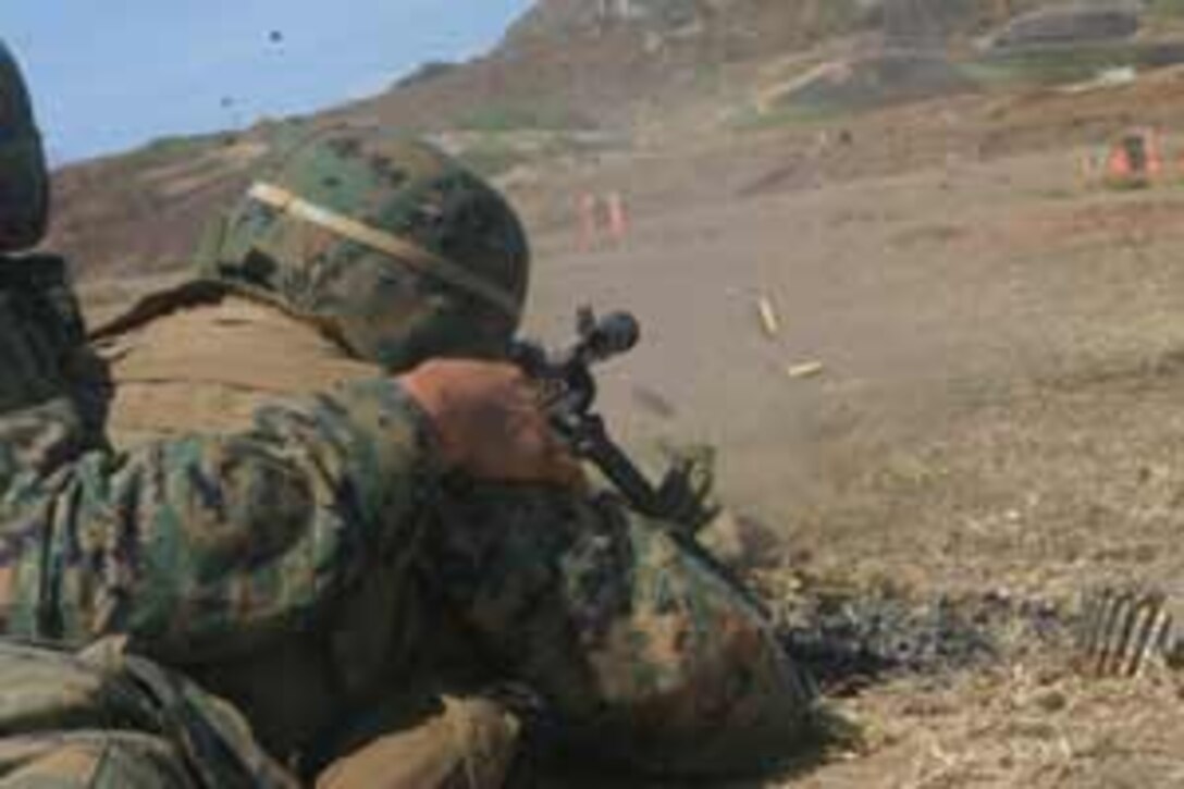 Spent shell cases fly from the gun's barrell as one of the Marines from Charlie Company fires his M240G machine-gun.
