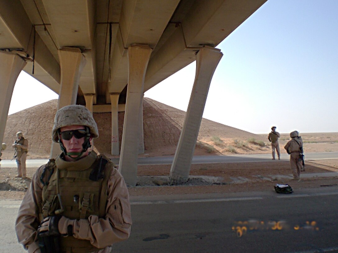 AL ASAD AIR BASE, Iraq -- Cpl. William G. Sheppard, a technical engineering specialist with 1st Combat Engineer Battalion, Regimental Combat Team 2, poses near a bridge that is in danger of collapsing. Sheppard was a part of the survey team sent to inspect the bridge. Photo Courtesy of 1st CEB.