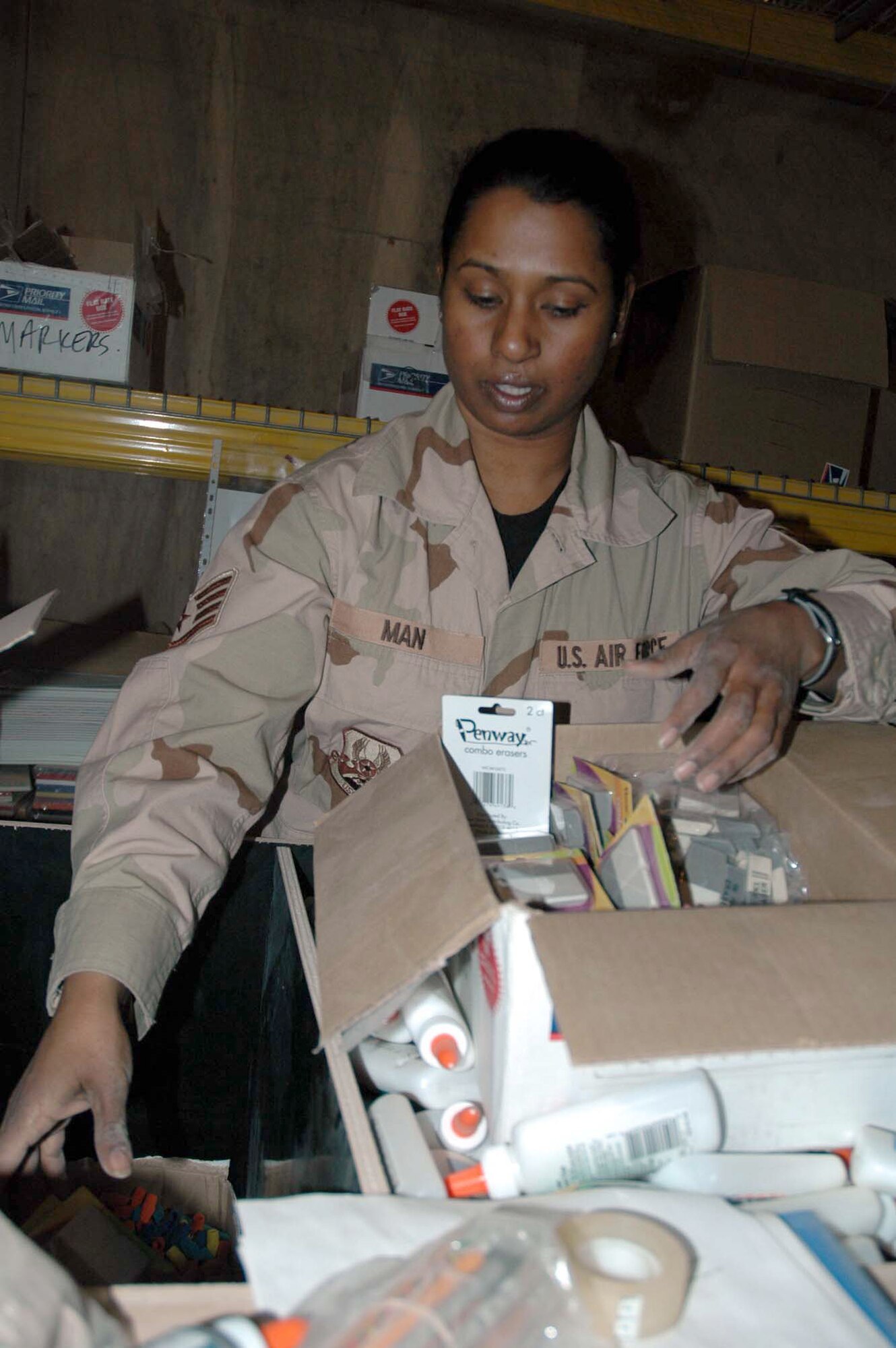 KIRKUK AIR BASE, Iraq (AFPN) -- Staff Sgt. Elizabeth Man sorts erasers donated to Operation Provide School Supplies. The project provides school supplies to children in the Kirkuk region. Sergeant Man is a chapel assistant deployed from Aviano Air Base, Italy. (U.S. Air Force photo by Staff Sgt. Kristina Barrett)