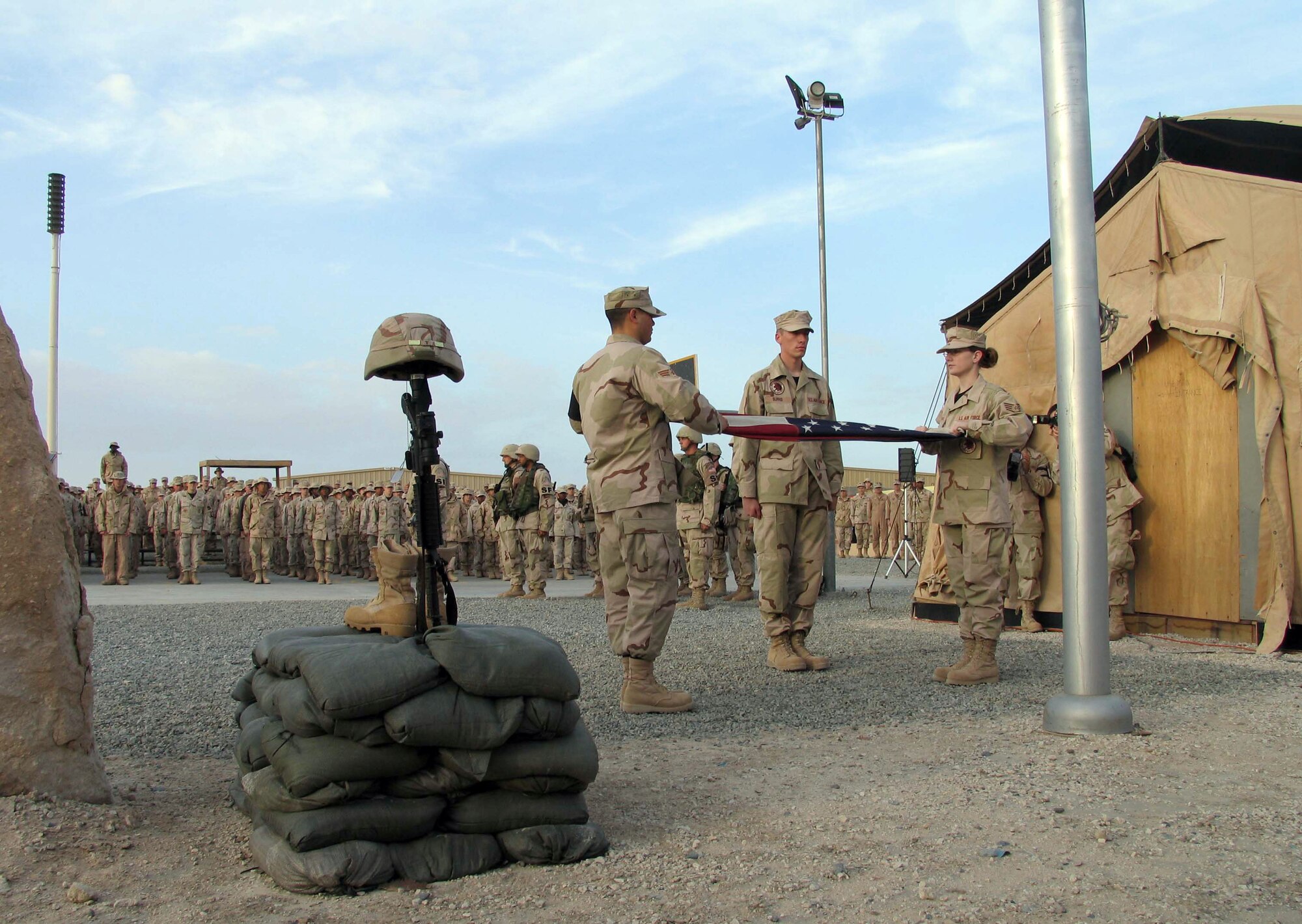 SOUTHWEST ASIA (AFPN) -- The 386th Air Expeditionary Wing's honor guard folds the flag during a memorial retreat here for two fallen Airmen Jan. 27. More than 500 people attended the retreat which honored Tech. Sgt. Jason Norton and Staff Sgt. Brian McElroy. The Airmen were killed in Iraq by an improvised explosive device Jan. 22. (U.S. Air Force photo by Staff Sgt. Patricia Findley) 
