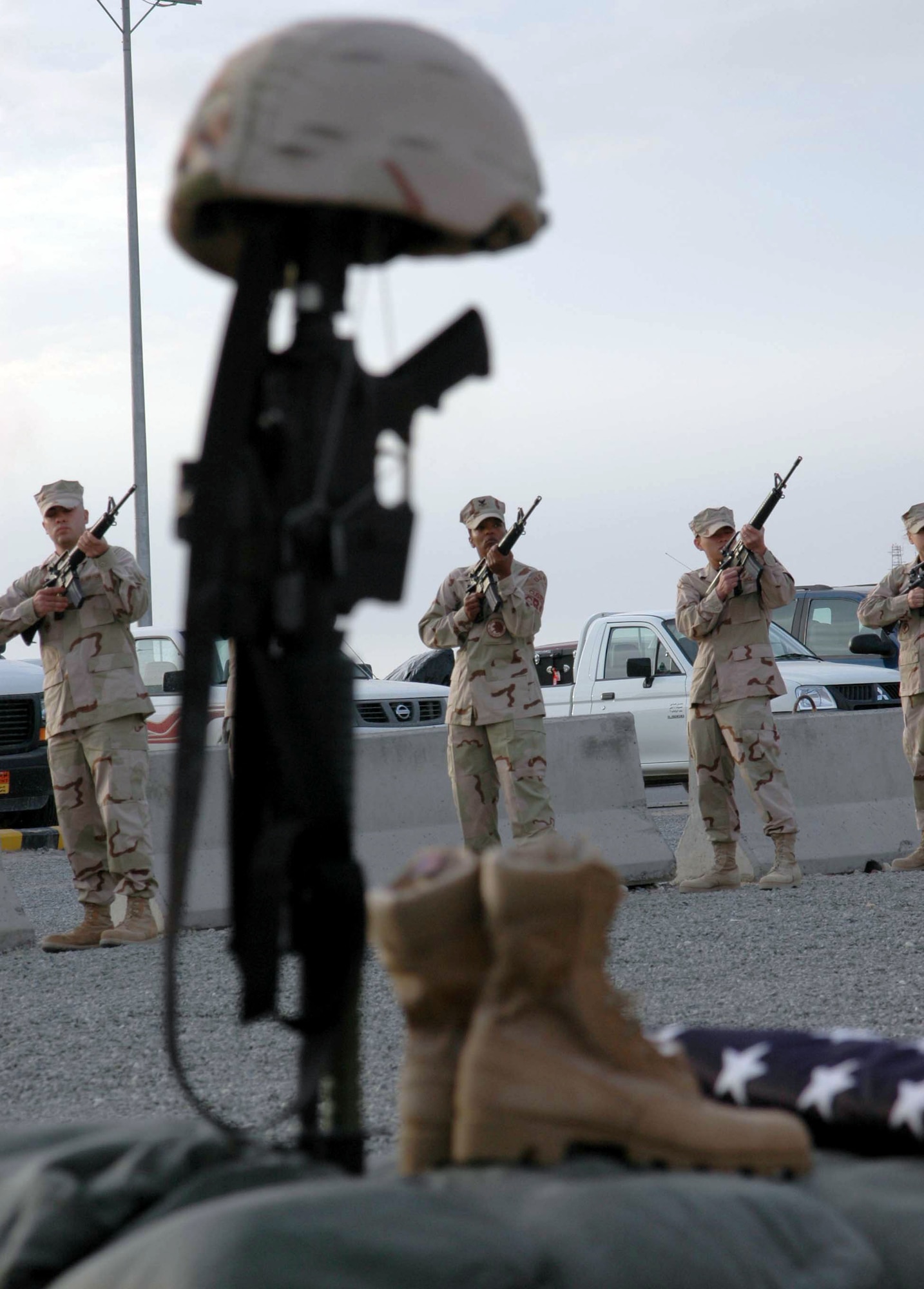 SOUTHWEST ASIA (AFPN) -- A firing party with the 386th Air Expeditionary Wing here performs a 21-gun salute for two fallen Airmen during a memorial retreat Jan. 27. More than 500 people attended the retreat which honored Tech. Sgt. Jason Norton and Staff Sgt. Brian McElroy. The Airmen were killed in Iraq by an improvised explosive device Jan. 22. (U.S. Air Force photo by Staff Sgt. Patricia Findley) 
