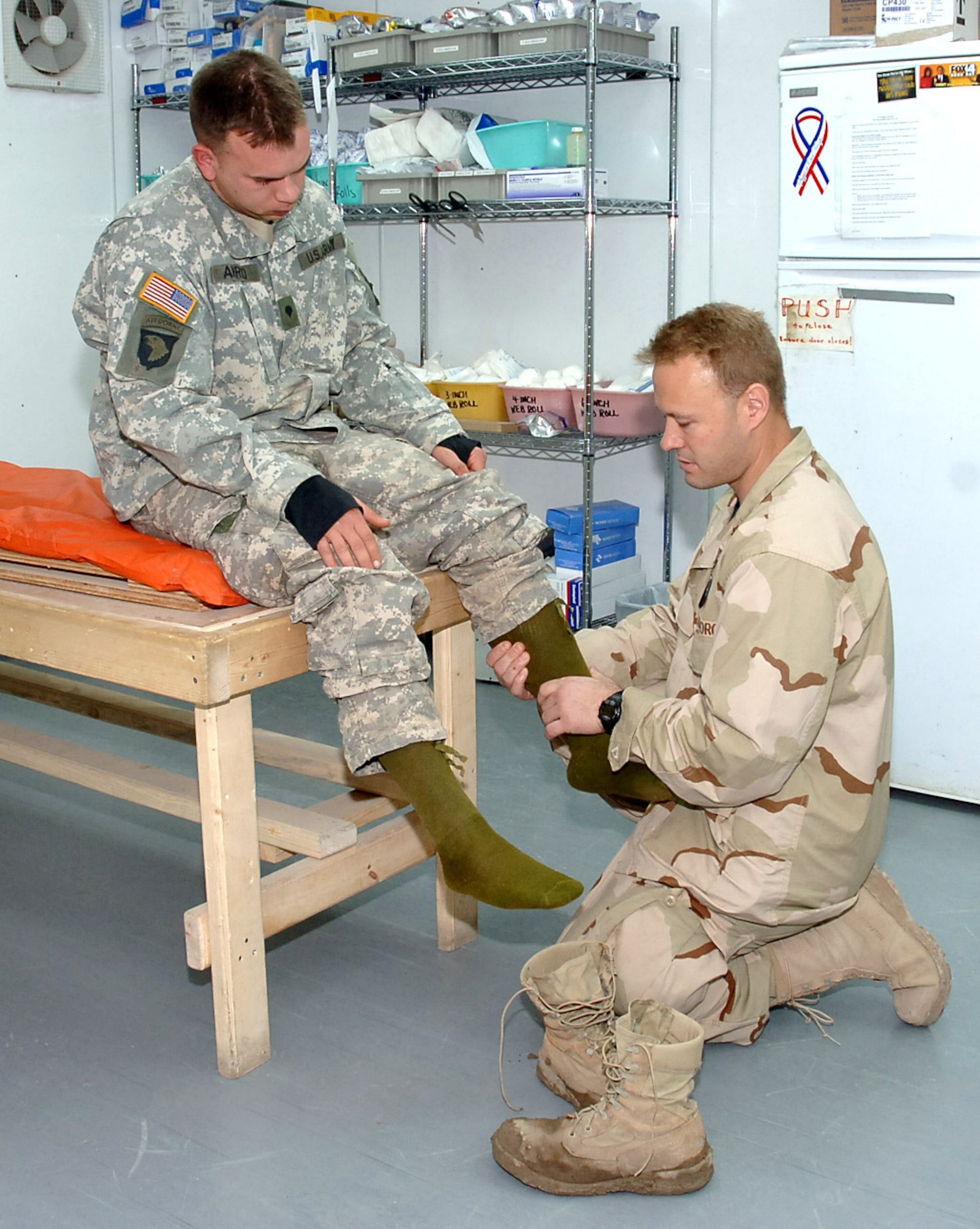 SATHER AIR BASE, Iraq (AFPN) -- Maj. (Dr.) J.T. Tokish checks Army Specialist Benjamin Arrigo, Headquarters Battalion 1-320, Victory Base Complex, for swelling at the new medical clinic at Sather Air Base. He is an orthopedic surgeon  with the 447th Expeditionary Medical Squadron which recently moved from old temper tents to a new 15,000-square foot modular clinic at Sather Air Base, Baghdad International Air Base, Iraq. The new clinic more than doubles the space available to the deployed medical team that provides primary and emergent medical care to Airmen at the air base and also to Department of Defense contractors, U.S. Army and Marines and Iraqi military forces based at the sprawling Victory Base Complex located at BIAP. (U.S. Air Force photo by Master Sgt. Will Ackerman)