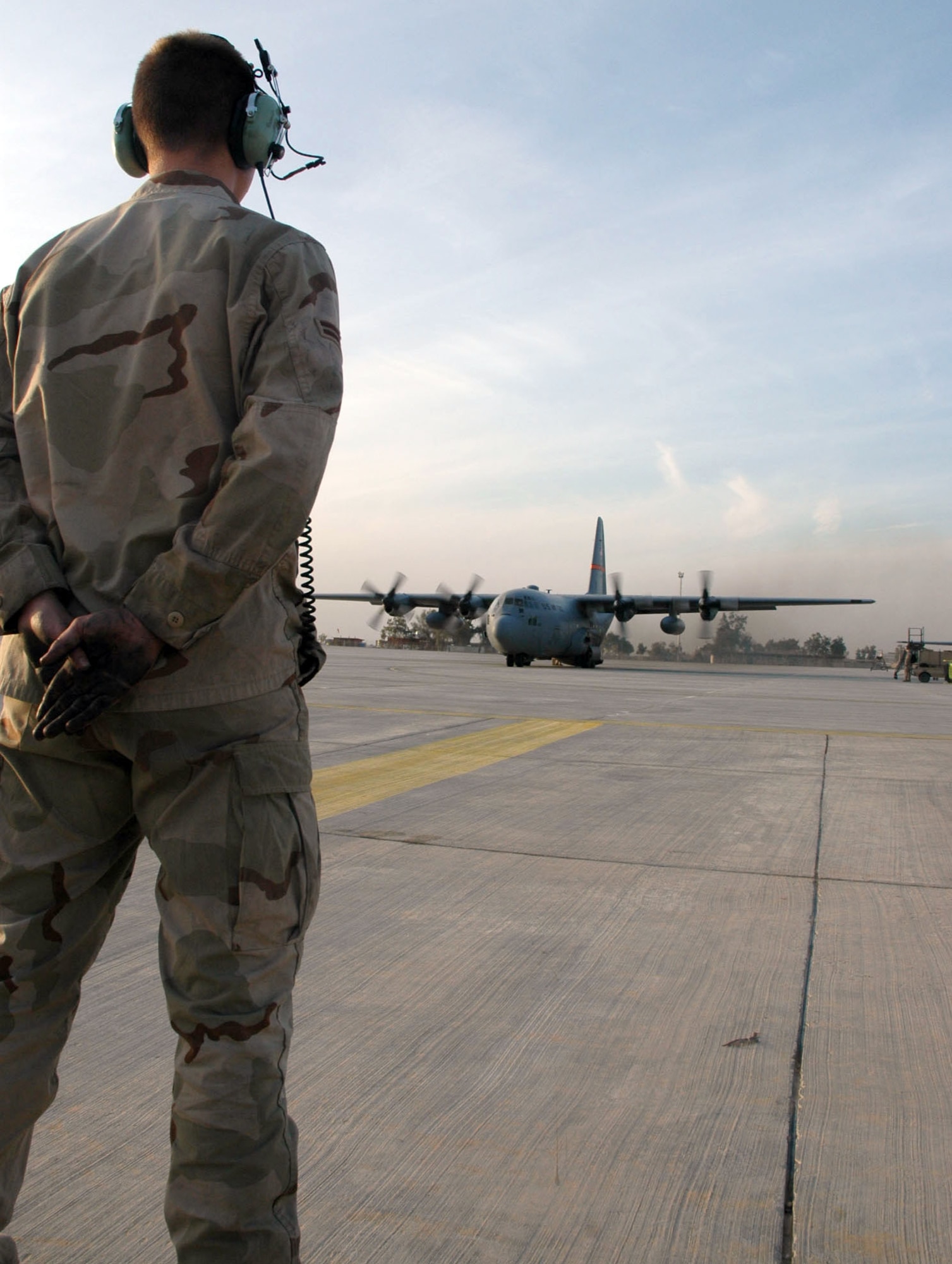 BALAD AIR BASE, Iraq (AFPN) -- Airman 1st Class James Money prepares to marshal a C-130 Hercules. He is deployed from the 463rd Aircraft Maintenance Squadron at Little Rock Air Force Base, Ark. (U.S. Air Force photo by 1st Lt. Jon Quinlan) 