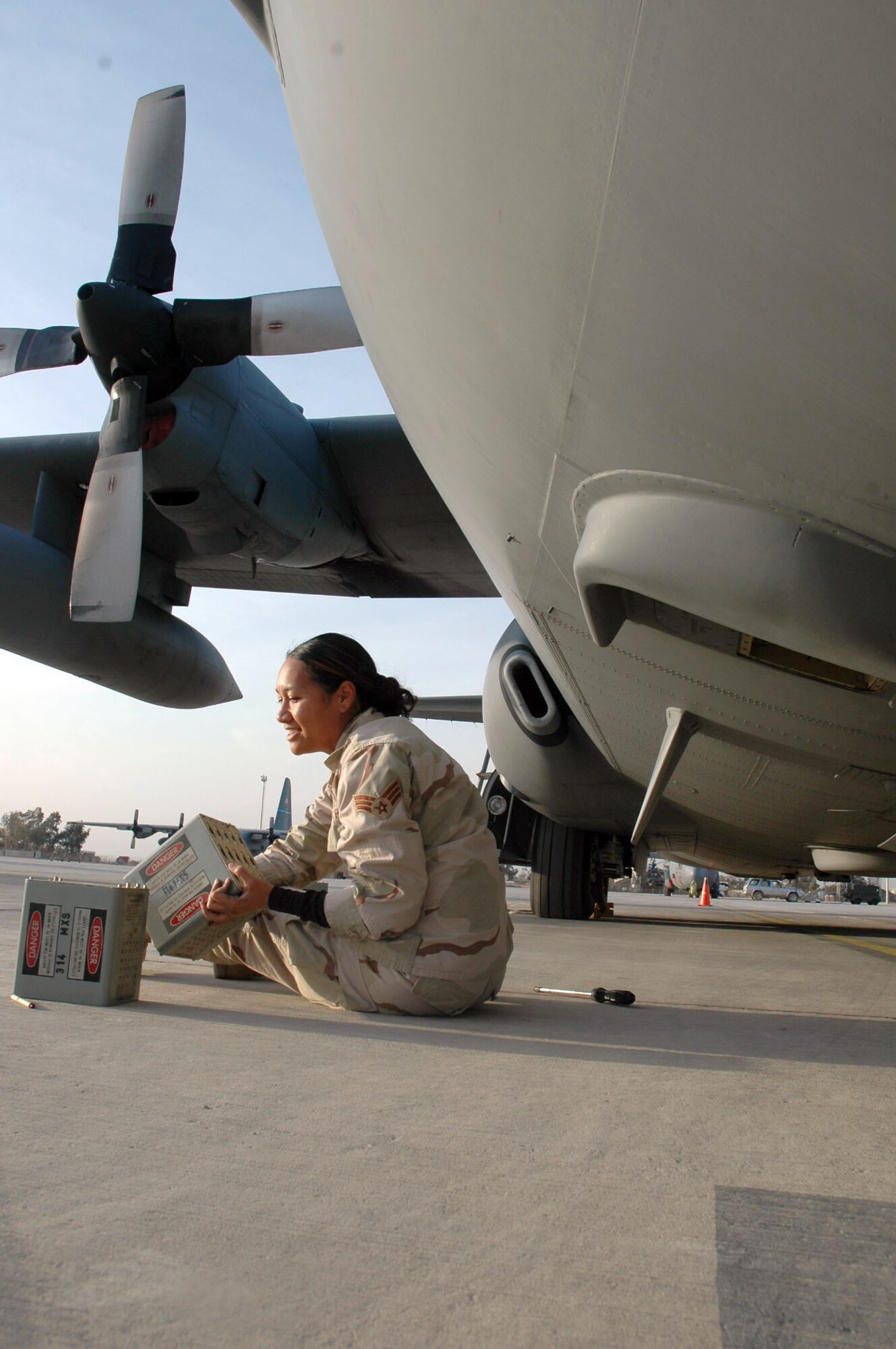 BALAD AIR BASE, Iraq (AFPN) -- Senior Airman BJ Enos replaces defensive flares for a C-130 Hercules stationed here. He is with the 777th Airlift Expeditionary Squadron deployed from Little Rock Air Force Base, Ark. (U.S. Air Force photo by 1st Lt. Jon Quinlan) 