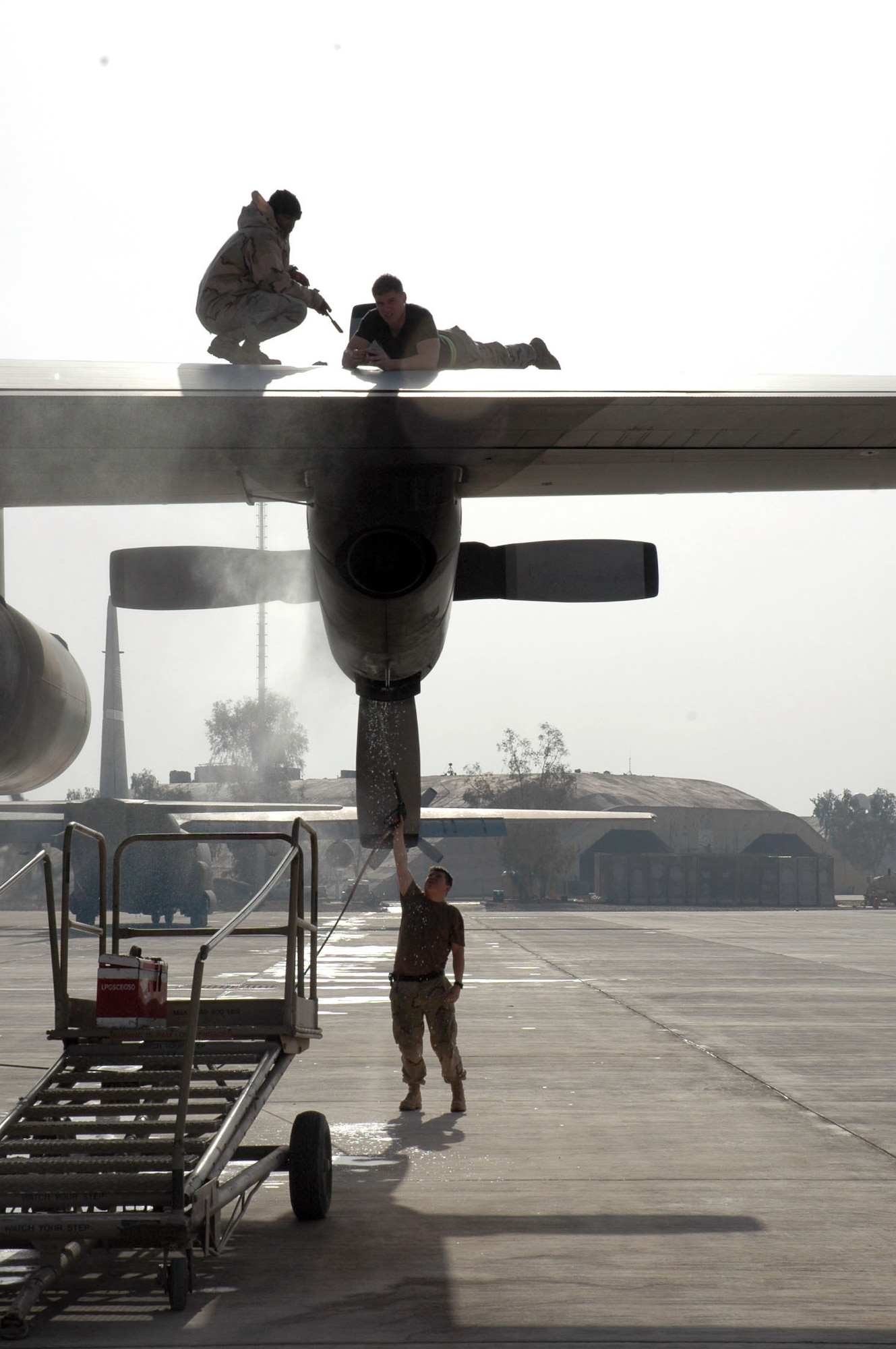 BALAD AIR BASE, Iraq (AFPN) -- 777th Airlift Expeditionary Squadron Airmen conduct maintenance on a C-130 Hercules stationed here. They are deployed from Little Rock Air Force Base, Ark. (U.S. Air Force photo by 1st Lt. Jon Quinlan) 