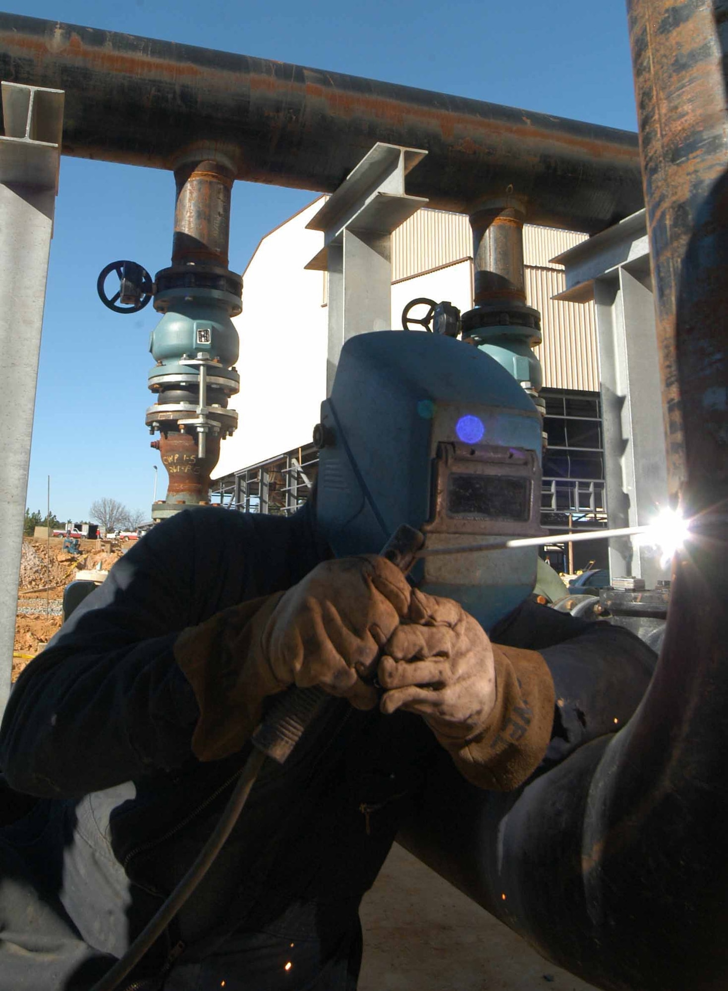 Dean Hummel welds a cooling unit at the new Corrosion Control Paint and Depaint Facility now under construction.  (Air Force photo by Sue Sapp)

