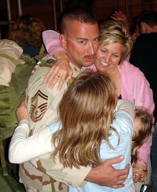 Senior Master Sgt. Michael Metzger, 482nd Maintenance Group, reunites with his wife, Connie, and his two daughters upon returning from Balad Air Base, Iraq on Friday evening, Jan. 20.  About 40 HARB Reservists returned after spending up to 120 days supporting Operation Iraqi Freedom. After leaving Iraq, they traveled through the Middle East, Germany, Iceland and Boston, Mass before arriving back at Homestead ARB (U.S. Air Force Reserve photo by Jake Shaw).
