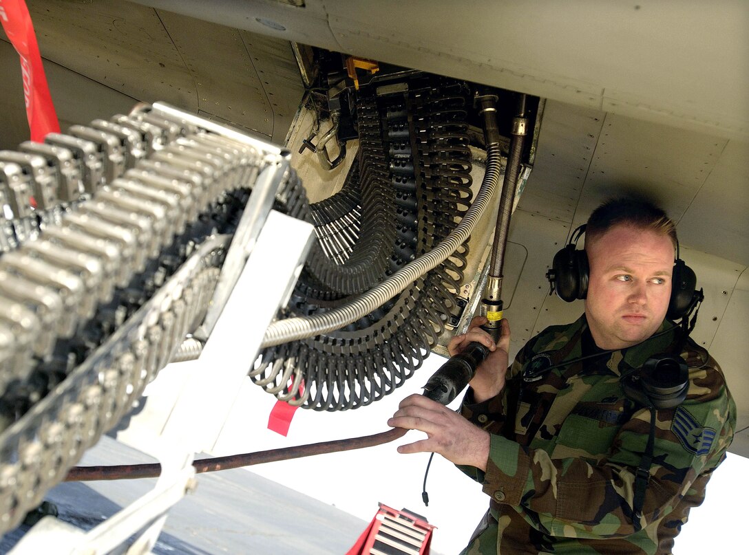 LANGLEY AIR FORCE BASE, Va. (AFPN) -- Staff Sgt. Jason Larkins loads ammunition into an F-15 Eagle during the load crew of the year event here in January. The event is part of the 1st Fighter Wing annual load competition and is the first one to include the F-22A Raptor.  The 71st Fighter Squadron won the competition. Sergeant Larkins is assigned to the 71st's aircraft maintenance unit. (U.S. Air Force photo by Senior Airman Austin Knox)