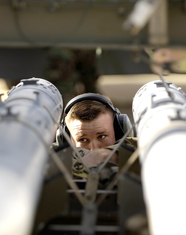 LANGLEY AIR FORCE BASE, Va. (AFPN) -- Senior Airman Tiegh Tinsley checks AIM-9 missiles before they are loaded onto the F-22A Raptor during the load crew of the year competition here.  The event was part of the 1st Fighter Wing annual load competition in January and is the first one to include the Raptor. Airman Tinsley is assigned to the 27th Fighter Squadron Aircraft Maintenance Unit.  (U.S. Air Force photo by Senior Airman Austin Knox)