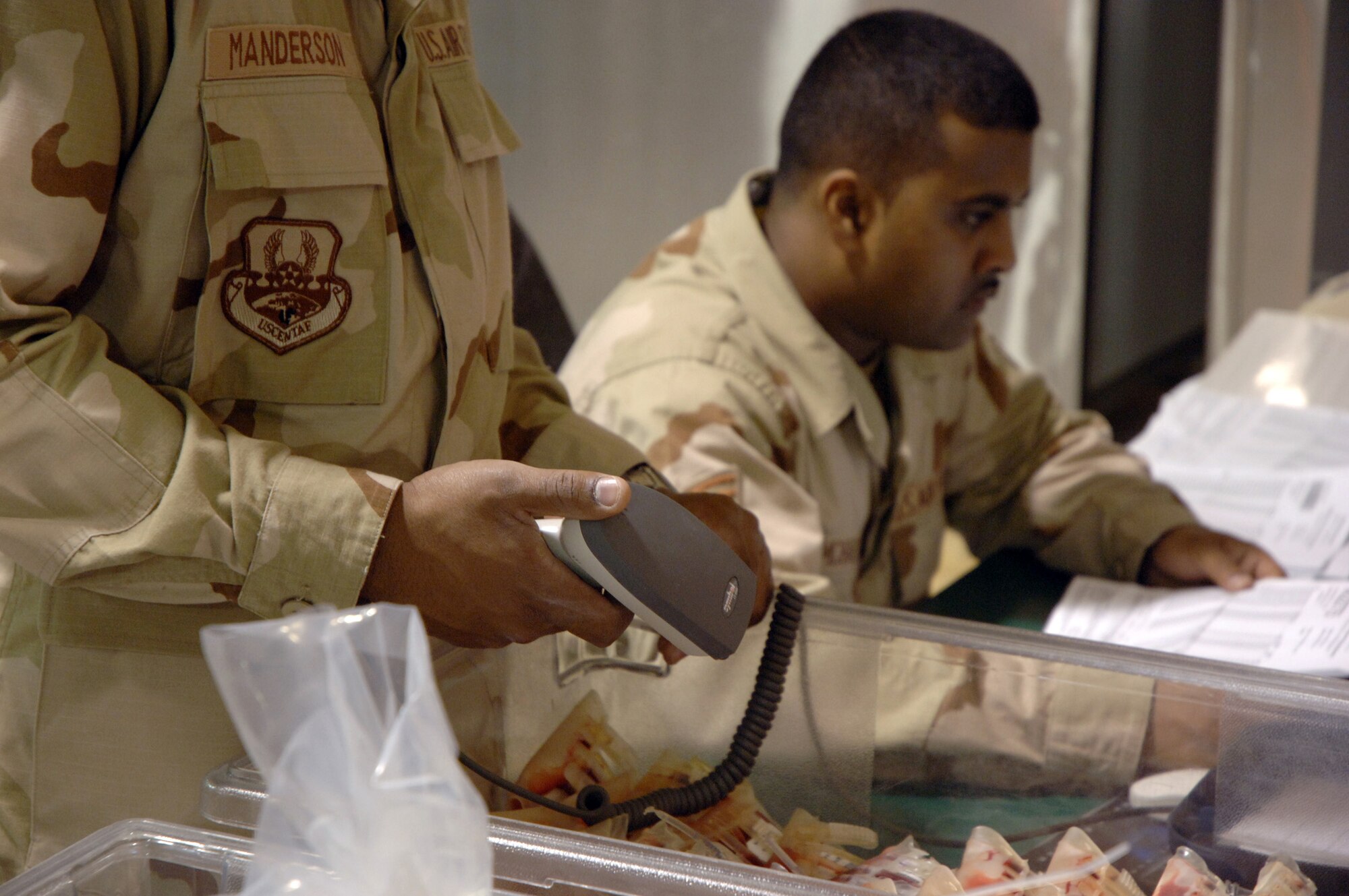 SOUTHWEST ASIA (AFPN) -- Airman 1st Class Roaquiem Manderson (left) and Staff Sgt. Ronell Ramcharitar inventory blood samples at the blood transshipment center here Jan. 28. The center gets blood from the United States and sends it throughout the region. Both Airmen are with the 379th Expeditionary Medical Support Flight and deployed from Langley Air Force Base, Va.  (U.S. Air Force photo by Staff Sgt. Joshua Strang)