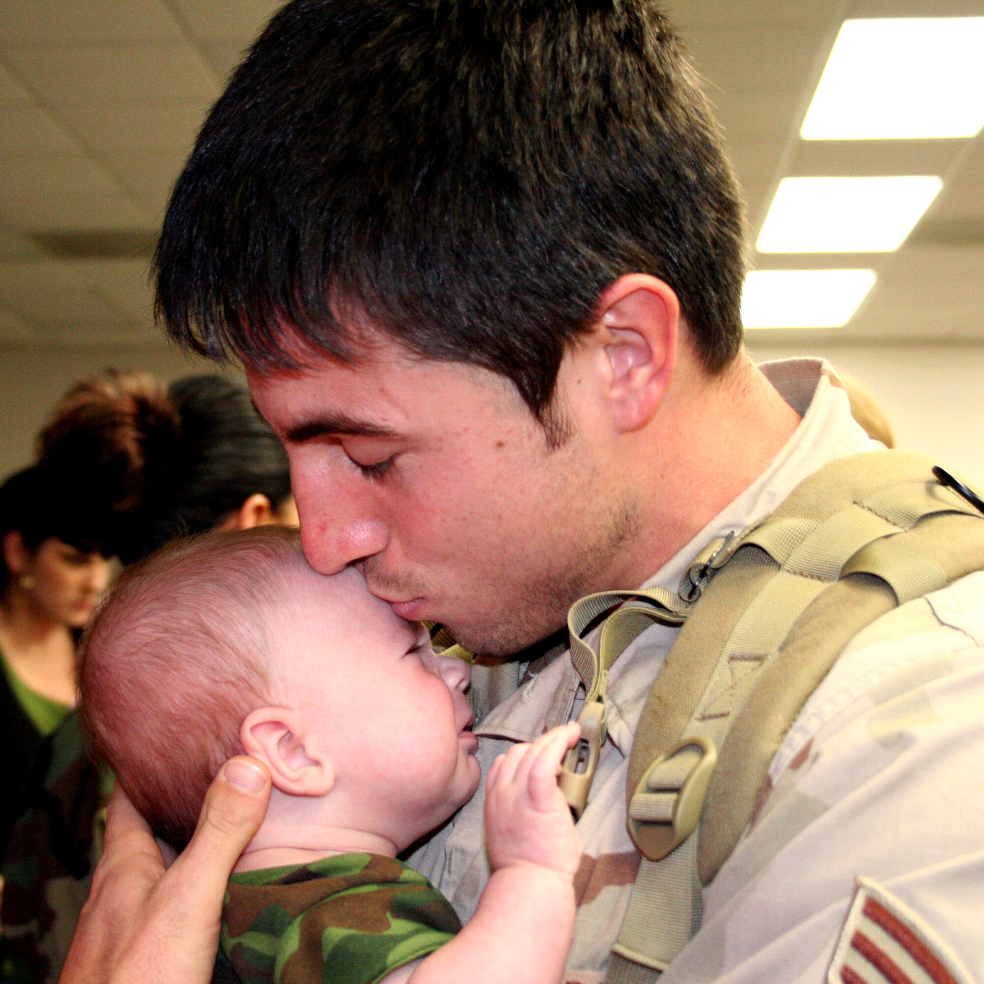 Senior Airman Robert McKlevey holds his 3-month-old son Cayden for the first time Jan. 19 at deployment control center at Hurlburt Field, Fla. Cayden was born while Airman McKlevey was deployed to Iraq from the 16th Civil Engineer Squadron. He and more than 100 Airmen from Hurlburt Field and neighboring Eglin Air Force base returned to the Florida panhandle after deploying to Southwest Asia.