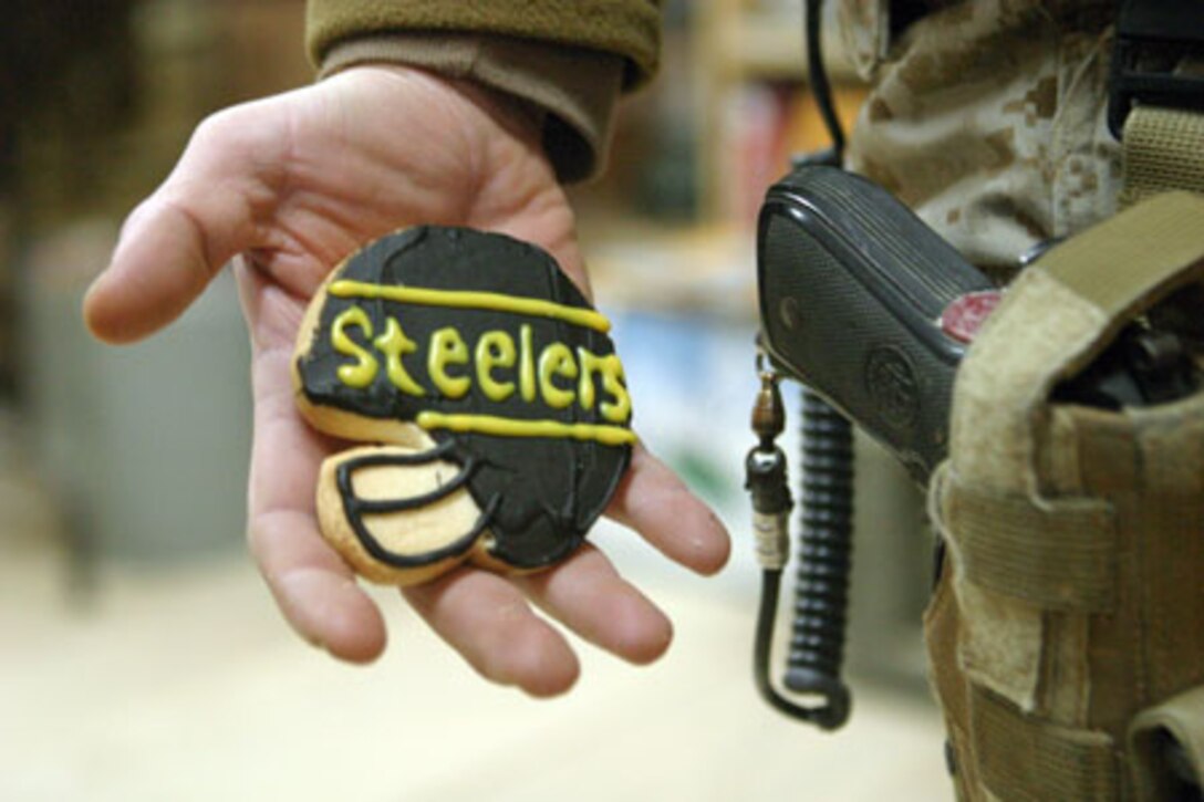 CAMP TAQADDUM, Iraq (Jan. 31, 2006) ? Lieutenant Col. Timothy B. Seamon, Capt. Trent Morrow, Gunnery Sgt. Stephen B. Johnson, Chief Petty Officer Mark F. Bryan, Capt. Charles T. Atwood stand posed with their Steelers memorabilia here Jan. 31. In Iraq, fans of the Pittsburgh Steelers and Seattle Seahawks hope their schedules will allow an opportunity to watch the game and support their team. These 2nd Marine Logistics Group (Forward) Marines may not be home with their immediate family to watch the game, but from thousands of miles away a few die hard fans hope for the victory of their gridiron favorite. Seamon (left) is the executive officer for Combat Logistics Regiment 25, and Baden, Pa. native, Morrow is Headquarters and Service company commander and his wife is a native of Mt. Lebanon, Pa., Johnson is the administration chief for CLR-25 and Washington, Pa. native, Atwood is a communications officer with CLR-25 and Monroeville, Pa. native, and Bryan is the regimental aid station for CLR-25, and Oil City, Pa. native.