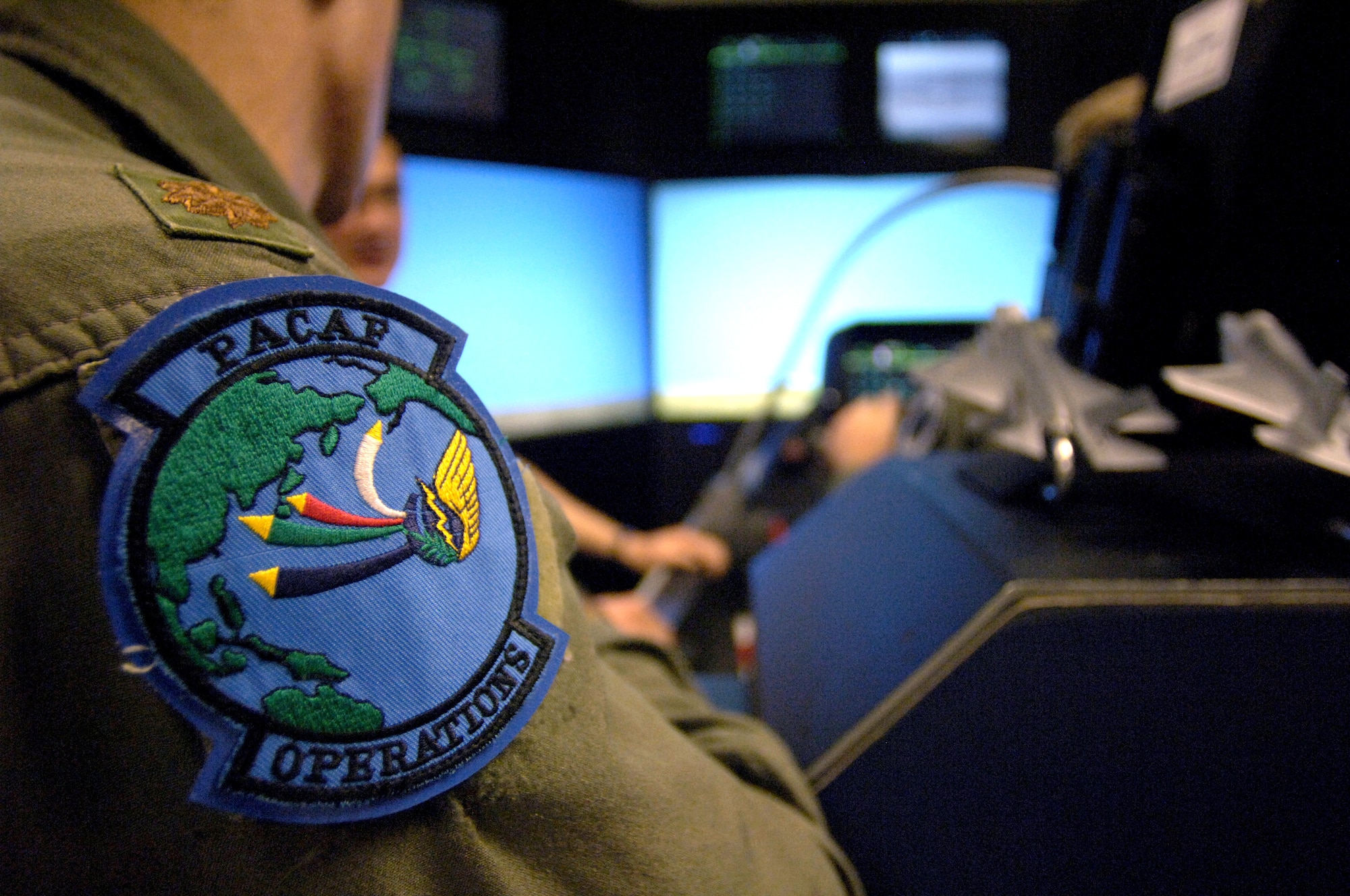 HICKAM AIR FORCE BASE, Hawaii (AFPN) -- Maj. Steve Biggs watches an F-35 Joint Strike Fighter simulator flight here. The simulator demonstrates the advanced capabilities of the F-35 -- the joint fighter of the 21st century. Major Biggs is from the Headquarters Pacific Air Force advanced programs office. (U.S. Air Force photo by Tech. Sgt. Shane A. Cuomo) 