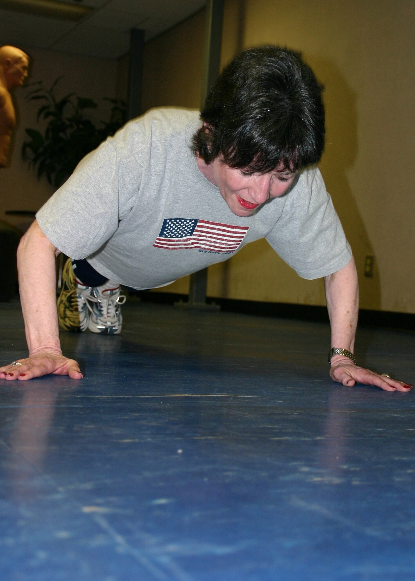 TINKER AIR FORCE BASE, Okla. (AFMCNS) - Bunny Greenroyd, 552nd Communications Group commander's secretary, performs an Air Force push-up.  A little less than a year ago the 58-year-old Greenroyd could only do one or two.  Now she can do 100. (Air Force photo by Staff Sgt. Stacy Fowler)
