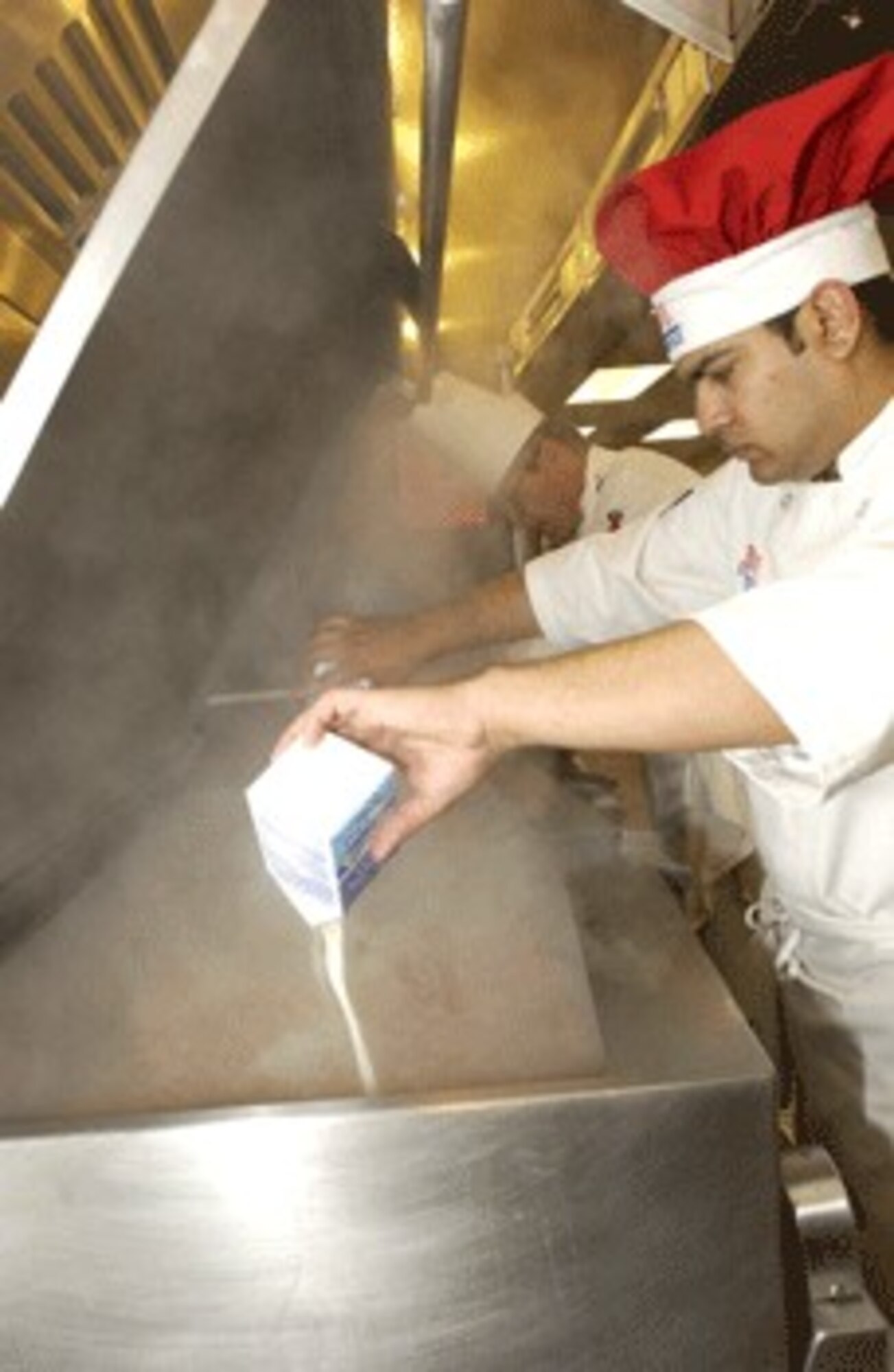 Airman 1st Class Mohammed Haroon makes chicken fricasse.