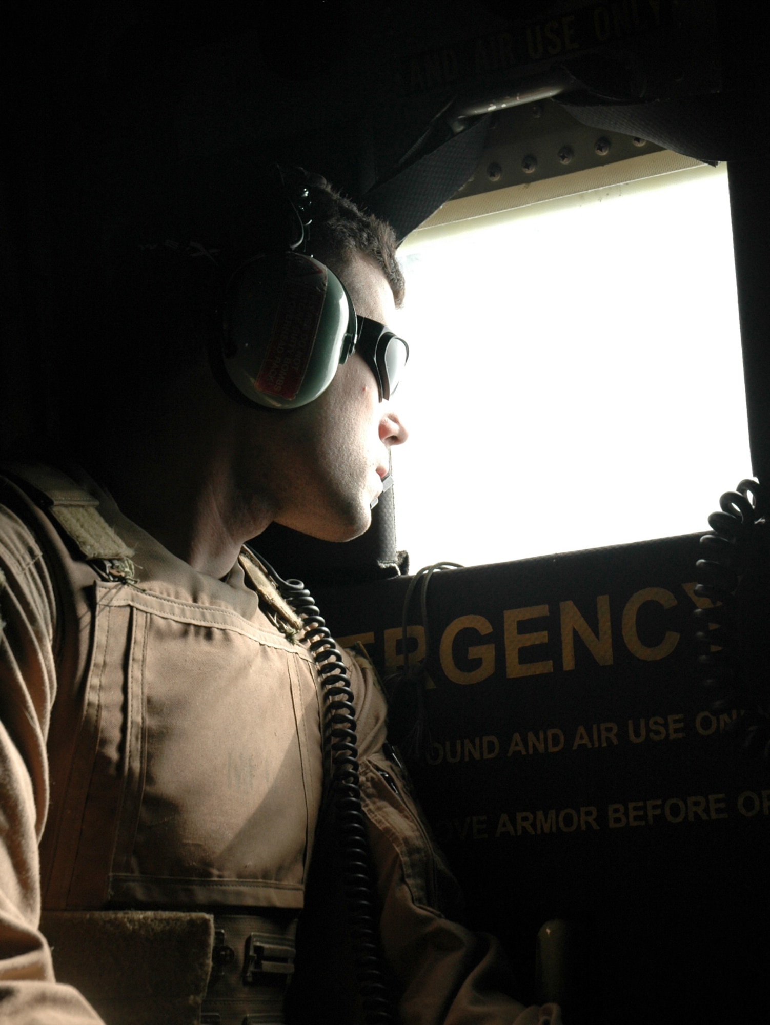 OVER BALAD AIR BASE, Iraq -- Senior Airman Jon Hall watches for threats out of a C-130 Hercules Jan. 26. He is a loadmaster with the 777th Airlift Expeditionary Squadron. (U.S. Air Force photo by 1st Lt. Jon Quinlan)