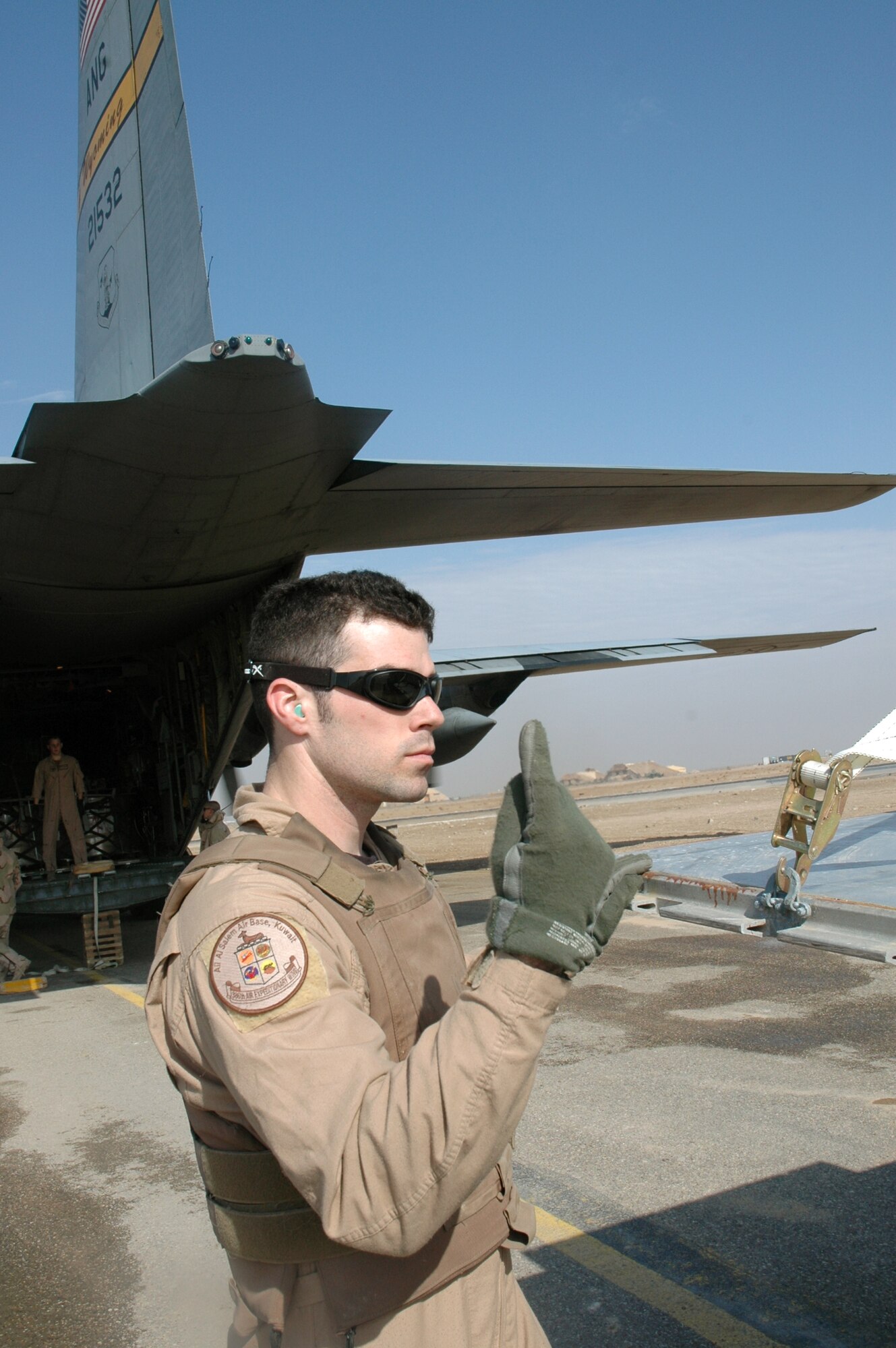 SOUTHWEST ASIA (AFPN) -- Senior Airman Jon Hall directs a forklift driver while loading a C-130 Hercules. He is a loadmaster with the 777th Airlift Expeditionary Squadron. (U.S. Air Force photo by 1st Lt. Jon Quinlan) 

