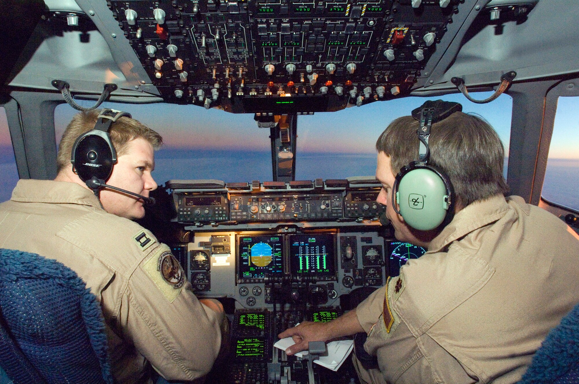 OVER IRAQ (AFPN) -- Maj. Eric Chancellor (right) and Capt. Brien Childress direct a C-17 Globemaster III during a mission over Iraq.  The pilots are with the Air National Guard's 183 Airlift Squadron from Jackson, Miss.  The unit's primary mission is to fly aeromedical evacuation missions. (U.S. Air Force photo by Master Sgt. John E. Lasky)
