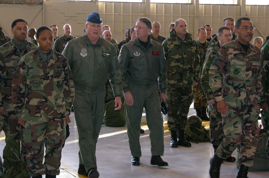 Air Force Reserve Commander, Lt. Gen. John Bradley, Col. Paul Sykes, 916th Air Refueling Wing commander (left) and Chief Thomas Smith, 916th ARW Command Chief enter the 916th Maintenance hangar just before a mass reenlistment ceremony. The 916th ARW is North Carolina's only Air Force Reserve wing and flies the KC-135R Stratotanker.