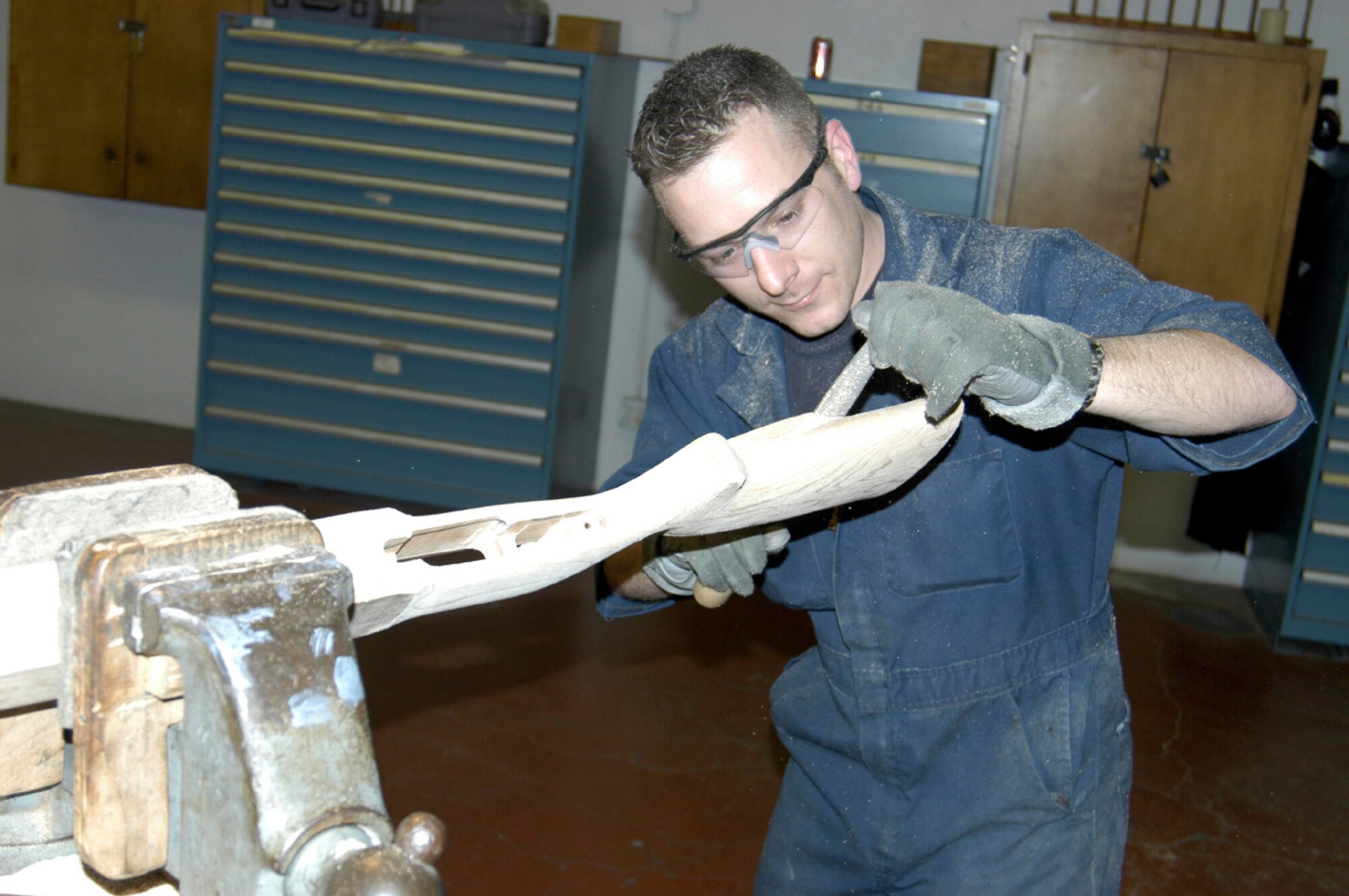 LACKLAND AIR FORCE BASE, Texas -- Staff Sgt. Brendan McGloin sands a wooden stock for a Remington .308-caliber rifle Jan. 20. Sergeant McGloin is a combat arms specialist with the U.S. Air Force Gunsmith Integrated Product Team here.  (U.S. Air Force photo by James Coburn)
