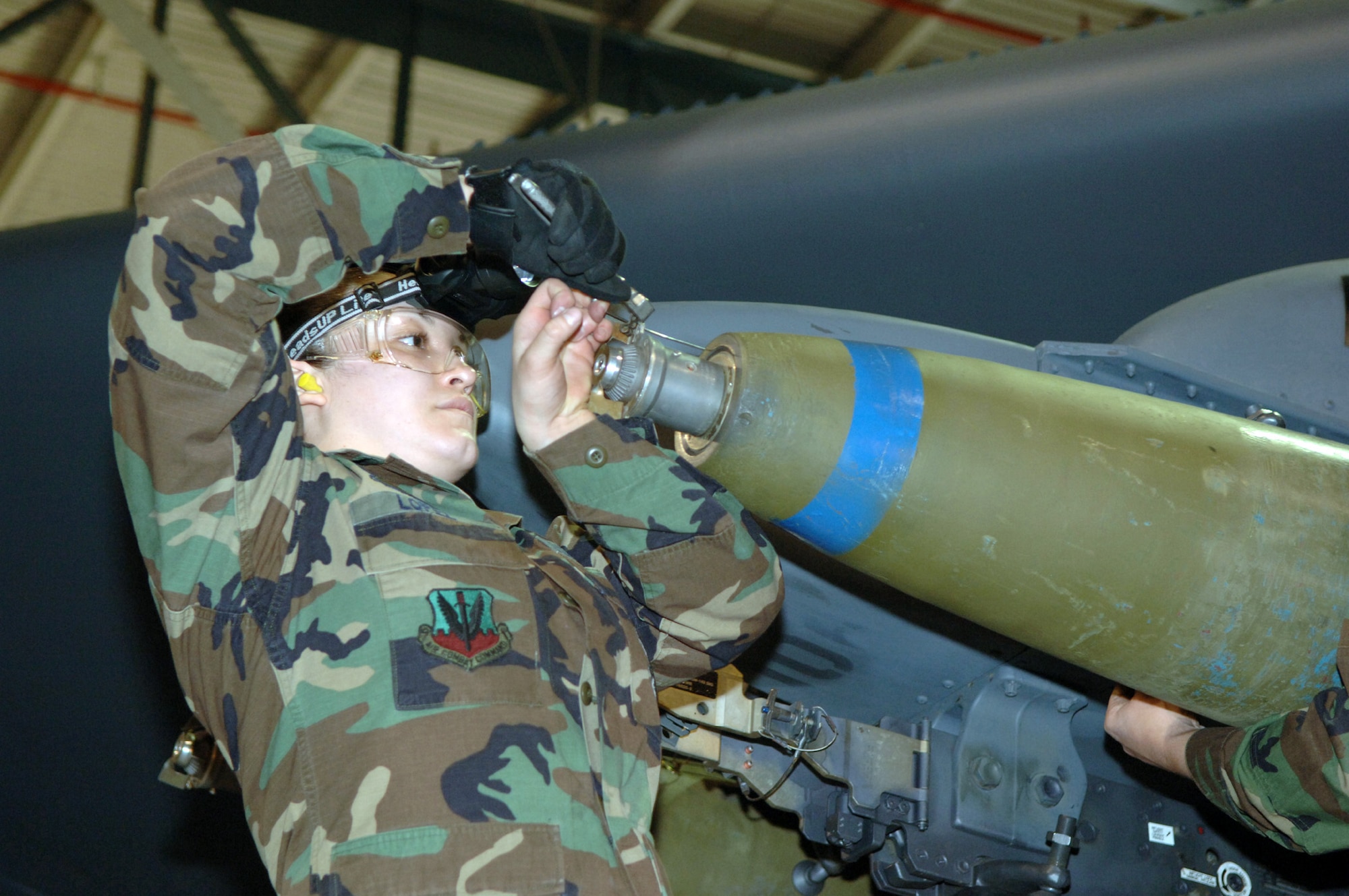 MINOT AIR FORCE BASE, N.D. (AFPN) -- Senior Airman Stephanie Lopez prepares a bomb during a load crew competition here Jan. 27.  The crews loaded nine Mk-82 500-pound general purpose bombs during the competition. The four-person crews were graded on teamwork, safety, precision and speed.  Airman Lopez is a weapons loader assigned to the 5th Aircraft Maintenance Squadron.  (U.S. Air Force photo by Airman 1st Class Christopher Boitz)