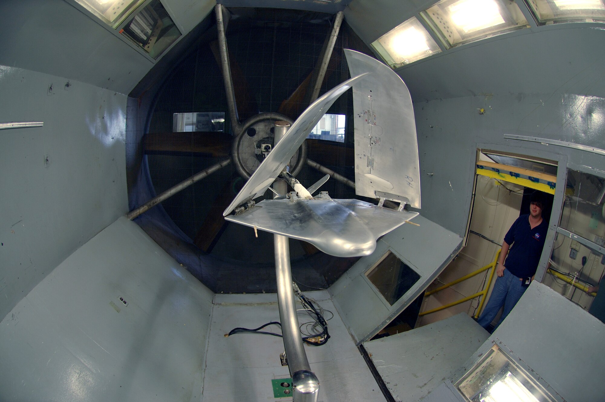 LANGLEY AIR FORCE BASE, Va. (AFPN) -- Steven Riddick glances at the aerial regional-scale environmental survey of Mars airplane during a break from testing at NASA's 12-foot low-speed tunnel here.  Mr. Riddick is an aerospace technology engineer who is part of the National Aeronautics and Space Administration wind tunnel team.  The airplane is being tested for its stability in various wind conditions and validation of its aerodynamics. (U.S Air Force photo by Staff Sgt. Eric T. Sheler)