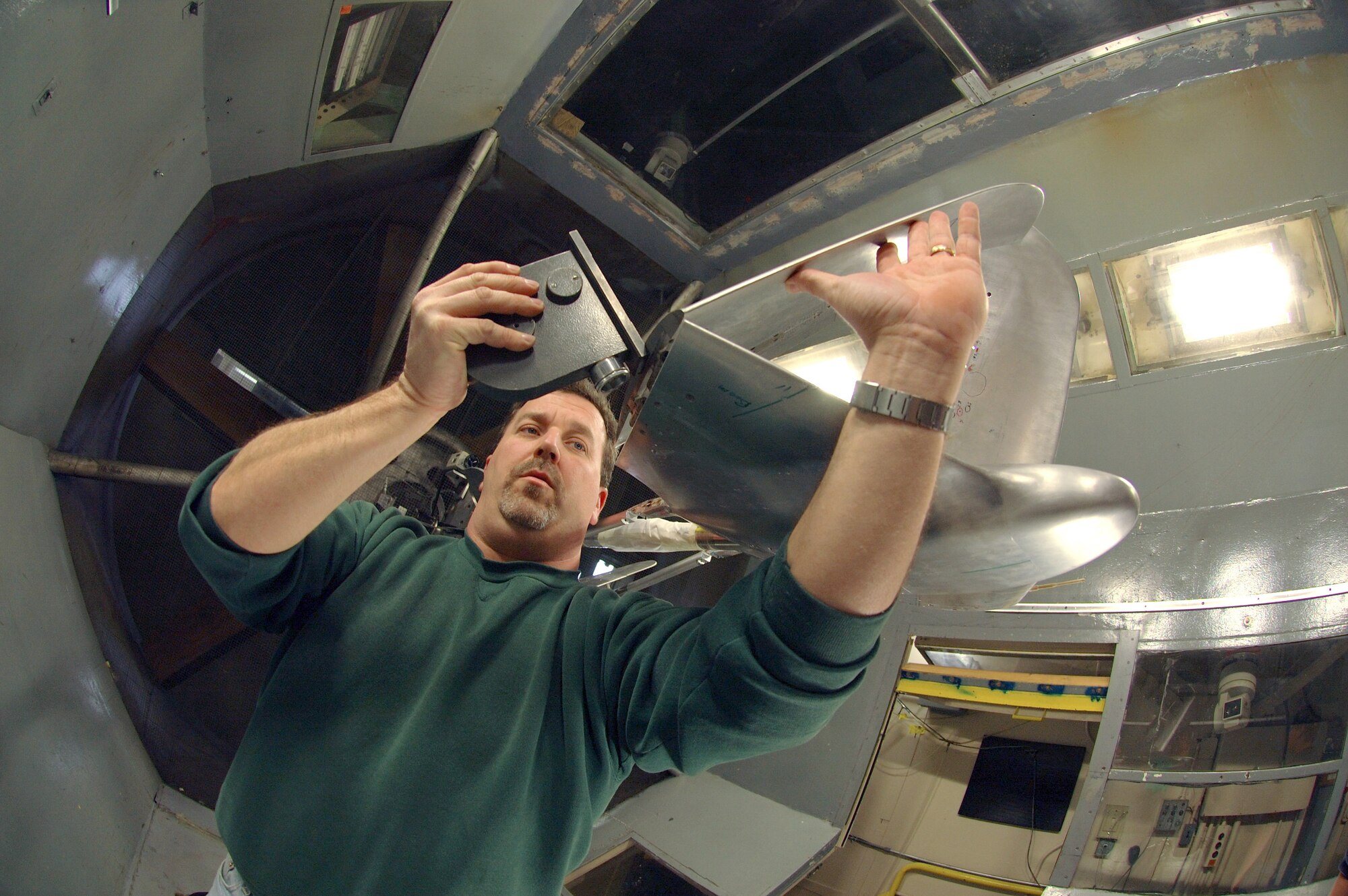 LANGLEY AIR FORCE BASE, Va. (AFPN) -- Earl Harris adjusts the wing fold of the aerial regional-scale environmental survey of Mars airplane in the NASA 12-foot low-speed tunnel here.  The tunnel will test the airplane for stability in various wind conditions and validate its aerodynamics. Mr. Harris is a mechanical engineering technician with the National Aeronautics and Space Administration. (U.S Air Force photo by Staff Sgt. Eric T. Sheler)