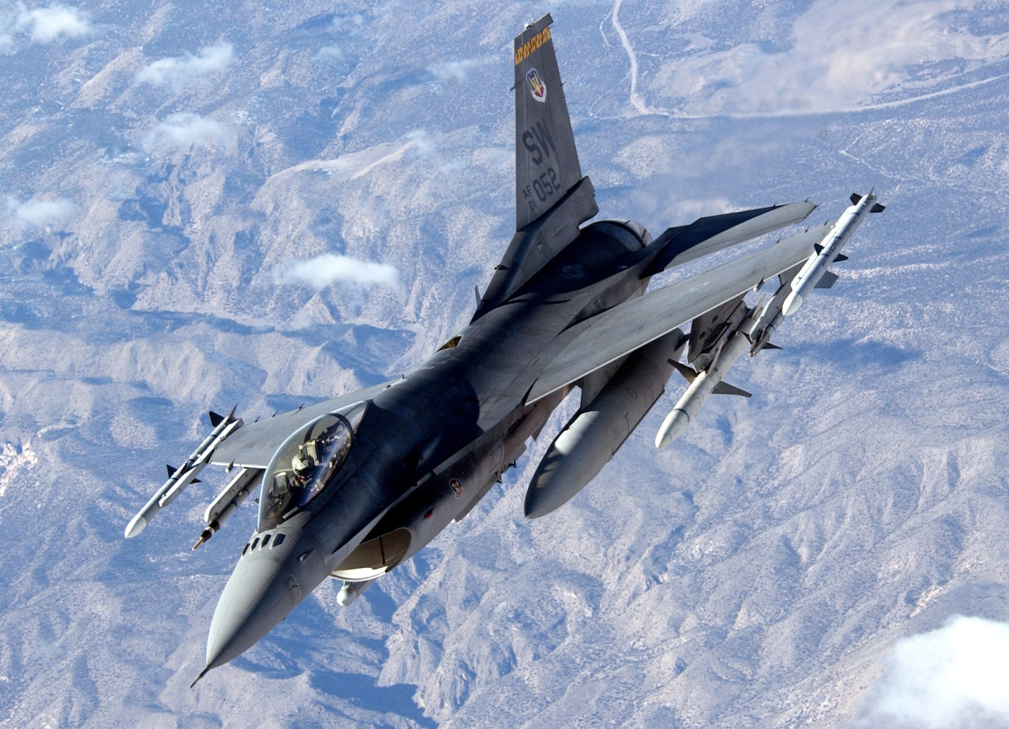NELLIS AIR FORCE BASE, Nev. (AFPN) -- An F-16 Fighting Falcon heads out to the ranges here Jan. 30, during Red Flag 06-1, held Jan. 21 through Feb. 18.  Red Flag tests aircrews' war-fighting skills in realistic combat situations. More than 85 aircraft, including B-2 Spirit bombers are involved. The aircraft are flying missions day and night to the nearby Nevada Test and Training Range where they simulate air war.  Along with the Air Force, units from the Army, Navy, Marine Corps, United Kingdom and Australia are participating. The F-16 is from the 20th Fighter Wing, Shaw Air Force Base, S.C. (U.S. Air Force photo by Master Sgt. Kevin J. Gruenwald)