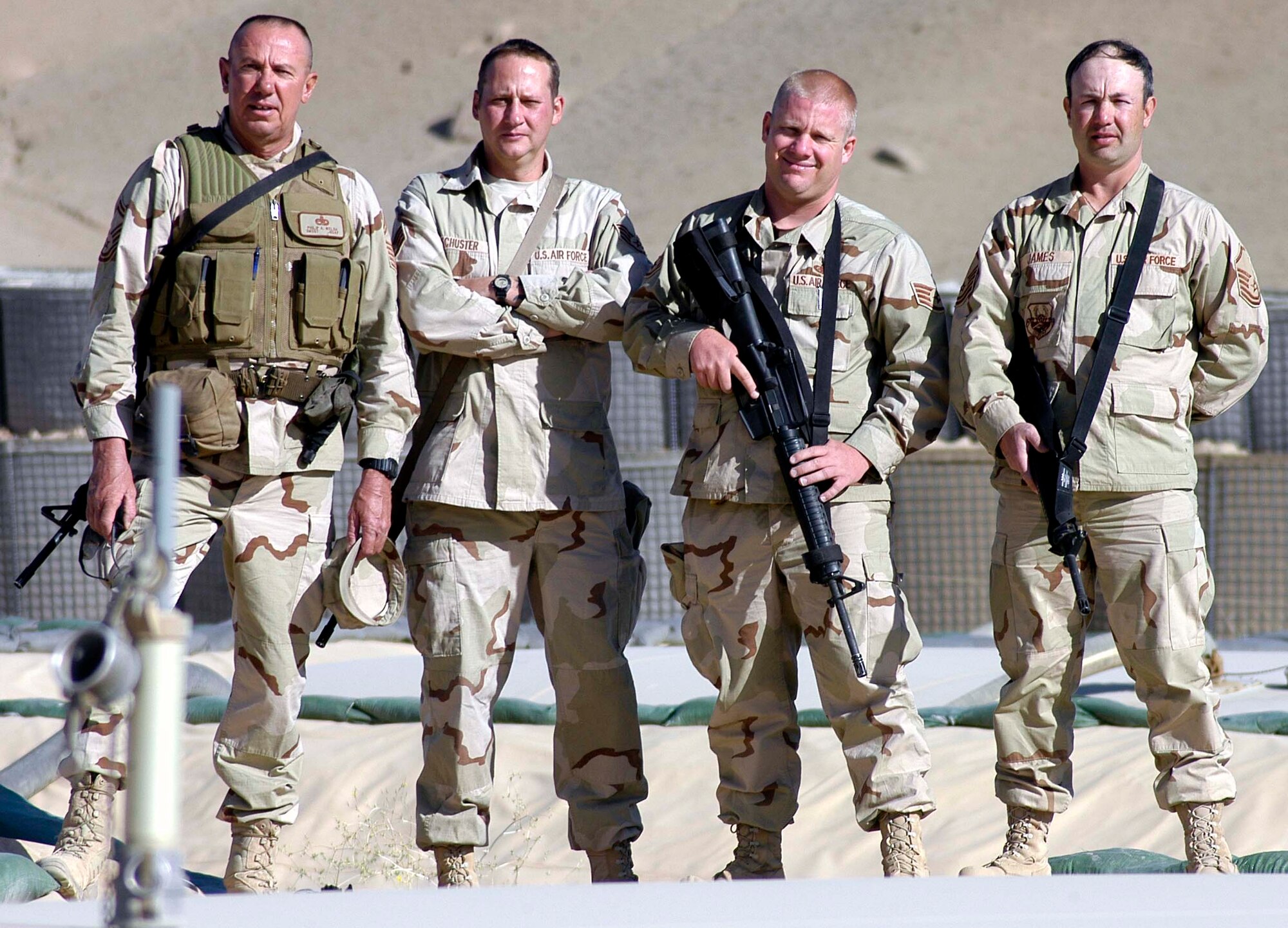 Left to right, Senior Master Sgt. Philip Welsh, Staff Sgt. Sean Schuster, Staff Sgt. William Cook and Master Sgt. Robert James stand in their fuel storage area at Chaghcharan Forward-Operating Base, Afghanistan.  The four Airmen are the only American military presence at the base run by the Lithuanian Military, which leads a multi-national team of military liaisons and observers in the Ghor province.  (US Air Force photo/Maj. David Kurle)