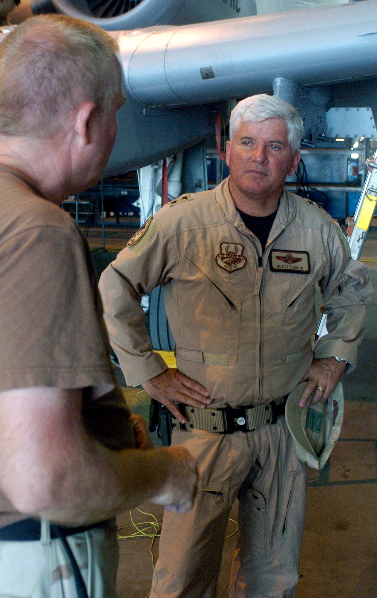 Maj. Gen. Allan Poulin, right, vice commander of Air Force Reserve Command, listens to Senior Master Sgt. Gary Thornberry in an A-10 maintenance hangar at Bagram Airfield, Afghanistan, June 28.  Sergeant Thornberry is an Air Force Reservist deployed to Bagram from the 442nd Fighter Wing at Whiteman Air Force Base, Mo.  General Poulin visited the base with Chief Master Sgt. Lawrence Chang, 10th Air Force command chief master sergeant.  (US Air Force photo/Maj. David Kurle)