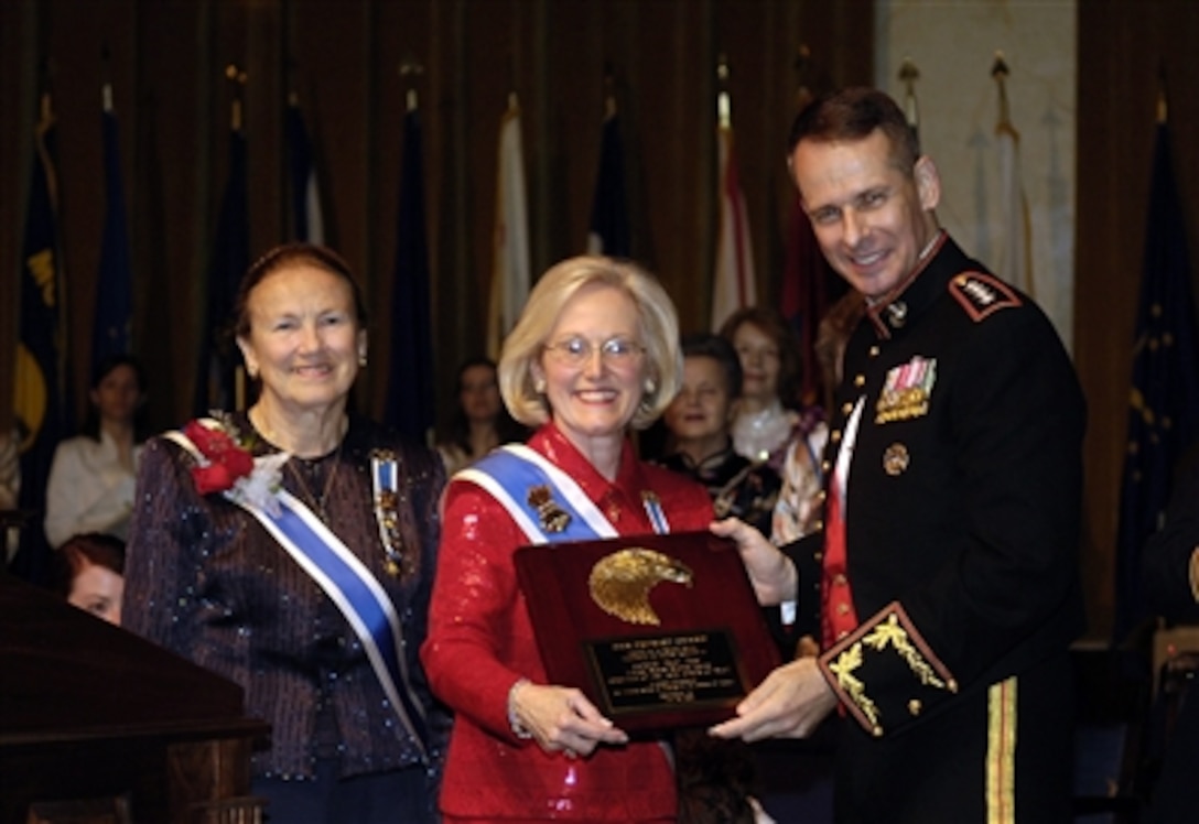 Presley Merritt Wagoner, Daughters of the American Revolution (DAR) President General, presents the Patriot Award to U.S. Marine Gen. Peter Pace, chairman of the Joint Chiefs of Staff, during a ceremony at Constitution Hall in Washington, D.C., June 30, 2006. Gen. Pace was invited to be the guest speaker at the annual DAR tribute to the American Armed Forces.