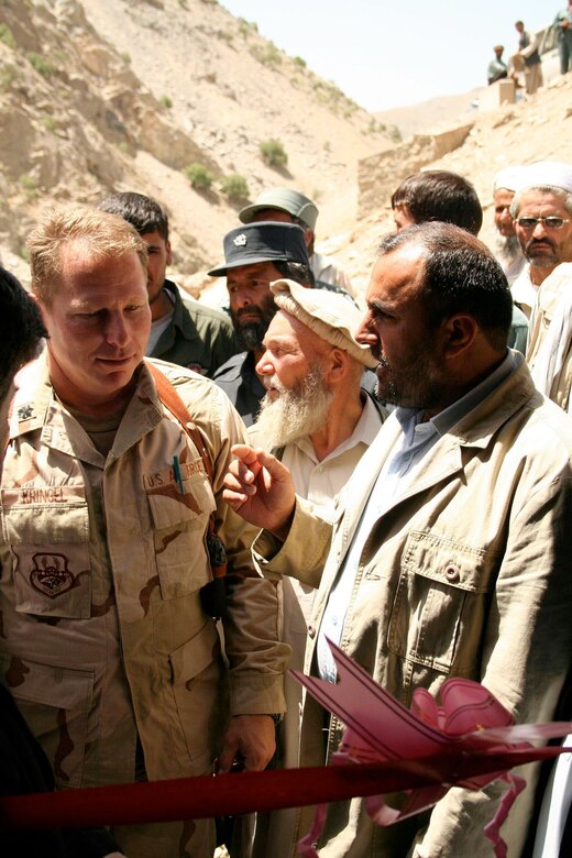 Panjshir Governor Haji Bahlol invites Lt. Col. Neal Kringel, Panjshir Provincial Reconstruction Team commander, to help him cut the ribbon at the dedication ceremony for the Shutol micro-hydropower plant on Wednesday, June 28. (Courtesy photo/Tech. Sgt. John Cumper)