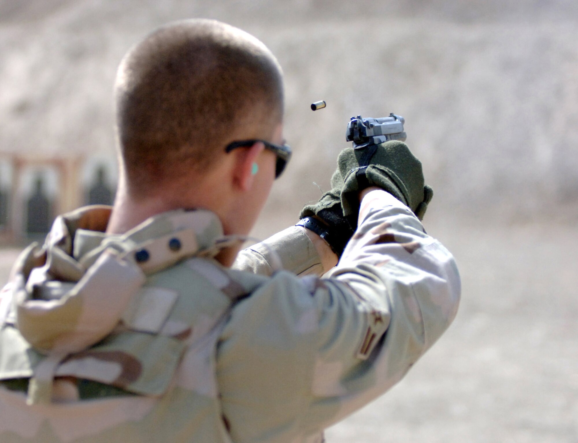 Airman 1st Class Brandon Newton fires an M-9 Beretta at a match at Victory Base Complex, Iraq, on Monday, July 3. Nine teams from Sather Air Base and Iraqi New Al Muthana Air Base competed, testing their endurance, skill and marksmanship. The four-person teams were made up of deployed Airmen from various career fields. Airman Newton is assigned to the 447th Air Expeditionary Group, and is deployed from the 96th Services Squadron at Eglin Air Force Base, Fla. (U.S. Air Force photo/Staff Sgt. Bryan Bouchard) 