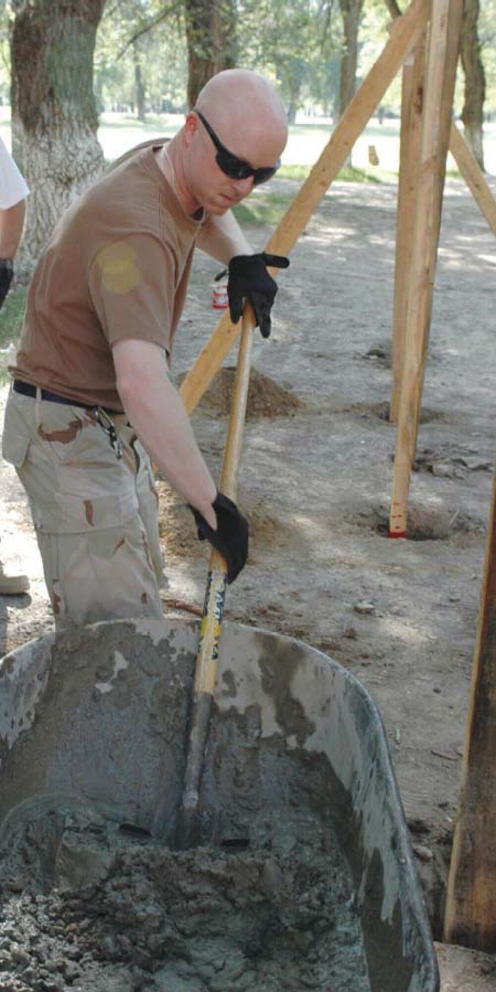 Tech. Sgt. Billy Bowman, 376th Civil Engineer Squadron, deployed from Elmendorf, prepares cement for the new Oktobersky Village School #1 children’s playground at Manas Air Base, Kyrgyzstan.