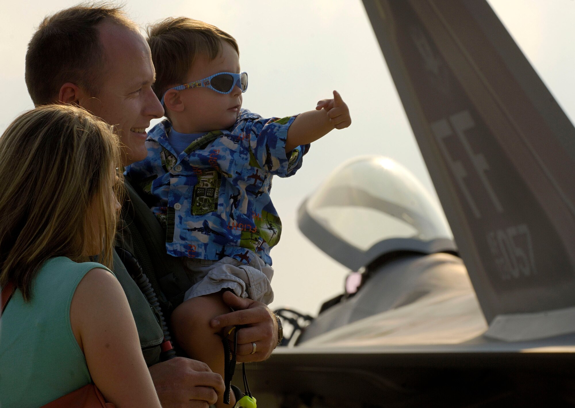 Capt. Daniel Lee shares a moment with his son, Benton, and wife, Rebecca, after arriving at Naval Air Station Oceana, Va., on Friday, June 30. The 27th Fighter Squadron, along with the 71st and 94th FS from Langley Air Force Base, Va., are flying sorties from other installations because of runway repairs at their home station. Captain Lee, who just returned from Elmendorf AFB, Alaska, is an F-22 Raptor pilot assigned to the 27th FS. (U.S. Air Force photo/Staff Sgt. Samuel Rogers)
