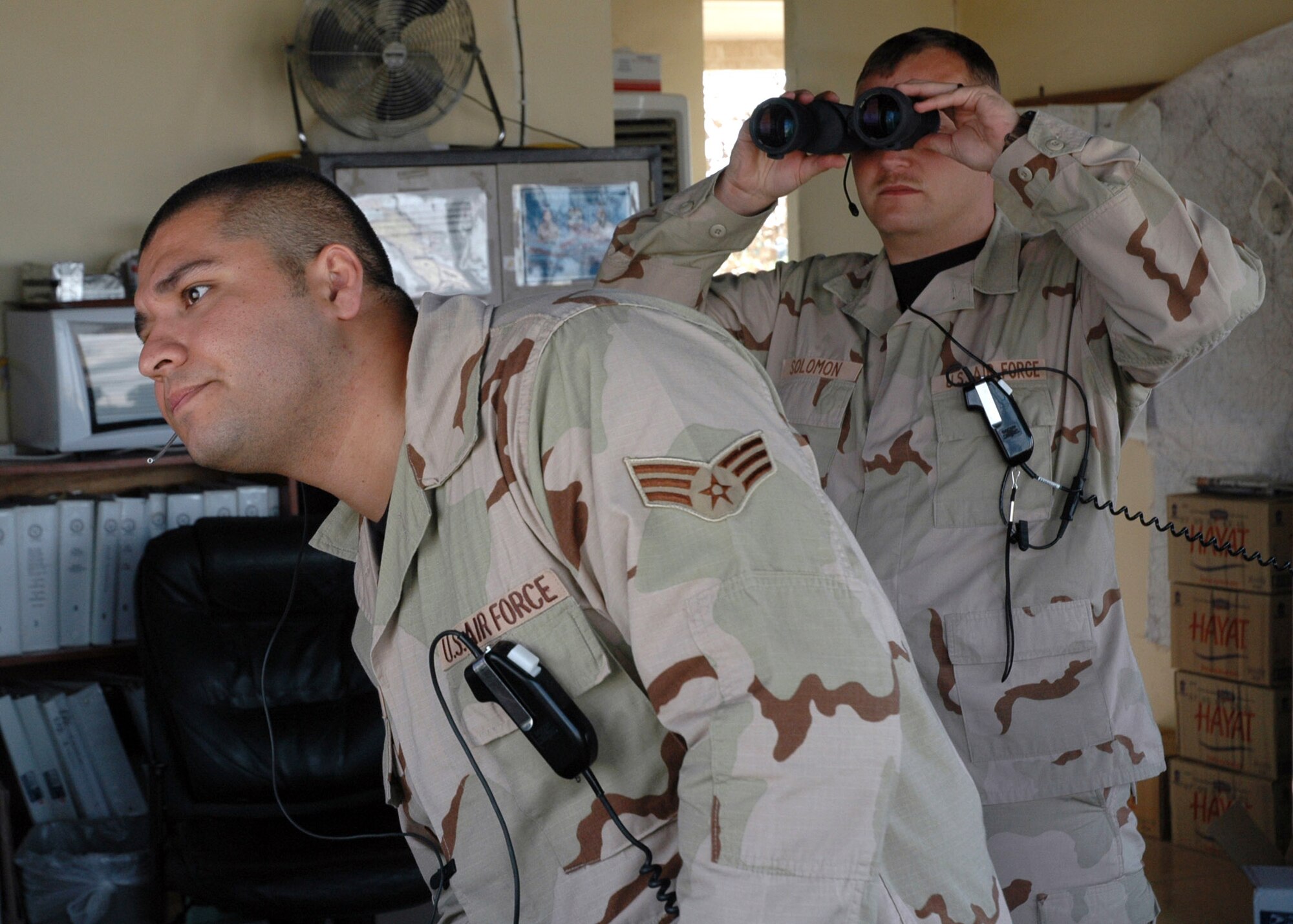Senior Airman Adam Guerrero (left) and Tech. Sgt. Christopher Solomon watch a C-17 Globemaster III come in for a landing from the air traffic control tower at Kirkuk Air Base, Iraq, on Monday, June 26. The two are assigned to the 506th Expeditionary Operations Support Squadron. (U.S. Air Force photo/Staff Sgt. Stacy Fowler)
