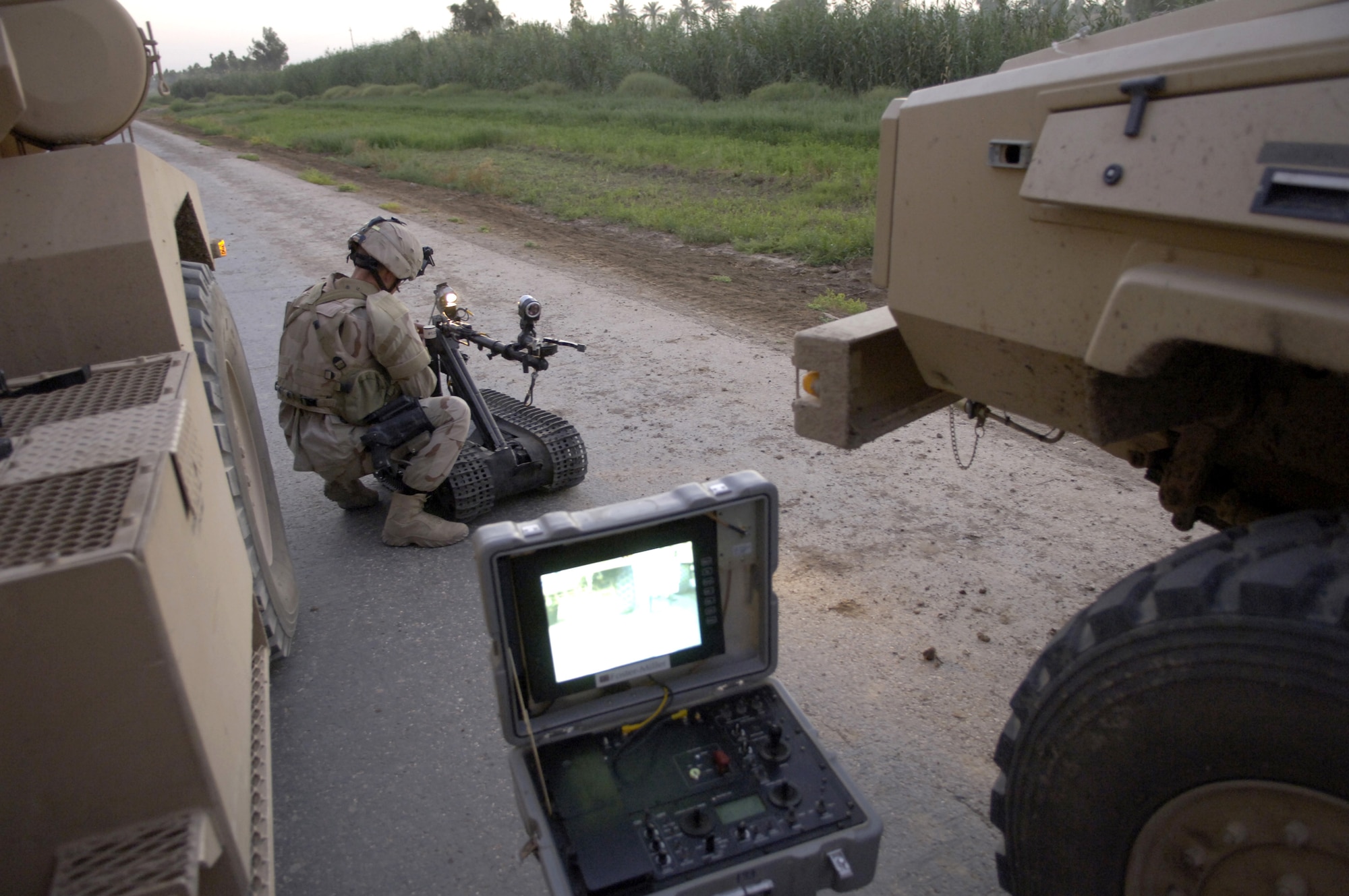 Senior Airman Scott White prepares a Talon robot before sending it to inspect a possible improvised explosive device, or IED, at a location southwest of Baghdad, Iraq, on Wednesday, June 28. The IED was found by an Army infantry unit. Airman White and two other explosive ordnance technicians were called to the scene to clear the area. Airman White is with the 447th Expeditionary Civil Engineer Squadron, and is deployed from Nellis Air Force Base, Nev. (U.S. Air Force photo/Senior Airman Brian Ferguson) 
