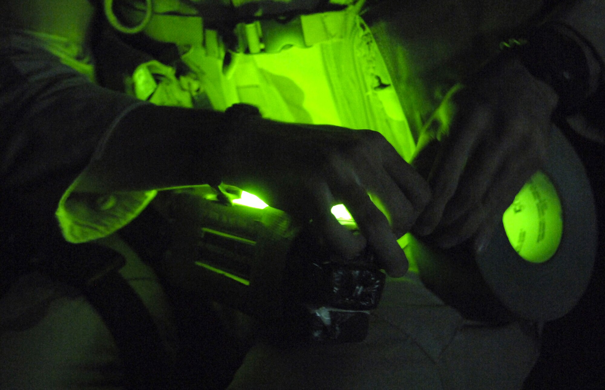 Senior Airman Scott White tapes a chemlight to a package of C-4 explosives before sending a Talon robot to inspect a possible improvised explosive device, or IED, at a location southwest of Baghdad, Iraq, on Wednesday, June 28. The C-4 is used to detonate the IED. Airman White and two other explosive ordnance technicians were called to the scene to clear the area. He is with the 447th Expeditionary Civil Engineer Squadron, and is deployed from Nellis Air Force Base, Nev. (U.S. Air Force photo/Senior Airman Brian Ferguson) 