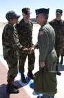 Chief Master Sgt. Carol Johnson, 60th AMW interim command chief, greets Maj. Gen. James A. Hawkins, 18th Air Force commander, while chief Master Sgt. Thomas Schwiesow, 615th Contingency Response Wing command chief accompanies them on Travis Air Force Base flightline. (Air Force photo by Laura Fentress)