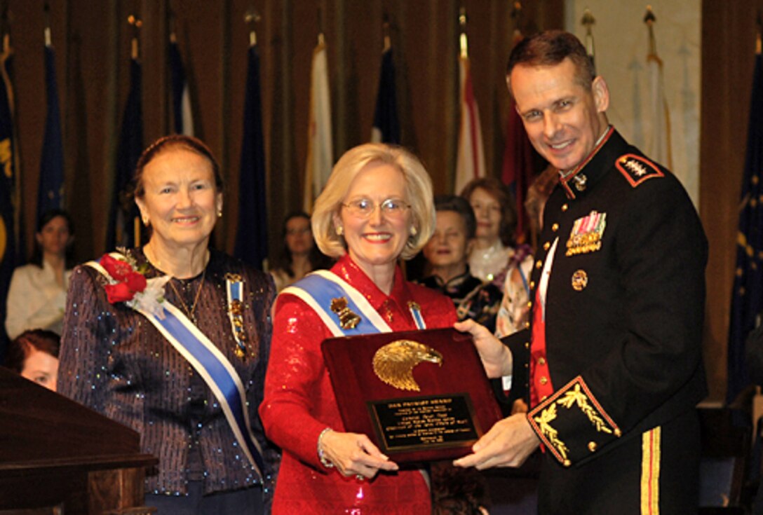 Presley Merritt Wagoner, Daughters of the American Revolution (DAR) President General, presents the Patriot Award to U.S. Marine Gen. Peter Pace, chairman of the Joint Chiefs of Staff, during a ceremony at Constitution Hall in Washington, D.C., June 30, 2006. Gen. Pace was invited to be the guest speaker at the annual DAR tribute to the American Armed Forces.