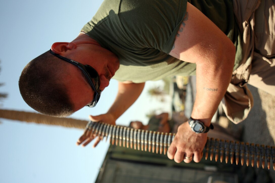 Lance Cpl. Danny M. Koleski Jr., a motor transport operator with Combat Logistics Detachment 115, inspects ammunition for his machine gun before leaving on a convoy to transport Iraqi policemen,  July 4, 2006. The detachment has been transporting Iraqi Army and Iraqi police throughout the city of Ramadi and working to build combat outposts in an effort to establish an Iraqi Army and police presence in the city. The detachment was formed from Combat Logistics Regiment 15 based at Camp Taqaddum east of here and is providing logistics support to the U.S. Armyâ??s 1st Brigade, 1st Armored Division currently responsible for security operations in the city.
