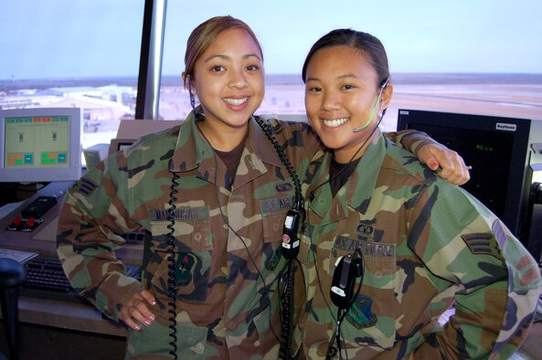 Senior Airman Jennifer Manibusan (left) and her cousin, Senior Airman Catherine Balolong, take a break from their air traffic controller duties at Laughlin Air Force Base, Texas, on Monday, June 26. Airman Manibusan, of Alameda, Calif., and Airman Balolong, of San Leandro, Calif., said serving together since basic training has helped them better adapt to Air Force. The two are with Laughlin's 47th Operations Support Squadron. (U.S. Air Force photo/Louis A. Arana-Barradas)