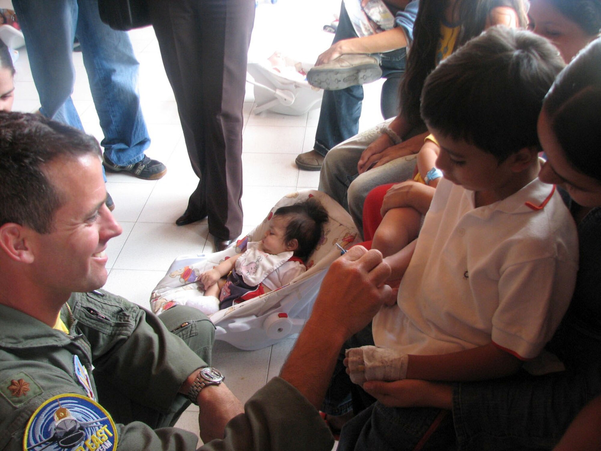 Maj. Jason Koltes visits with children at the Clinica Infantil Santa Ana, a children's hospital in Medellin, Colombia, on Sunday, July 2. Major Koltes is the commander and a pilot for the F-16 Fighting Falcon Viper East aerial demonstration team. The team was in Colombia for the Rio Negro air show. (U.S. Air Force photo/1st Lt. Christina Mundy)
