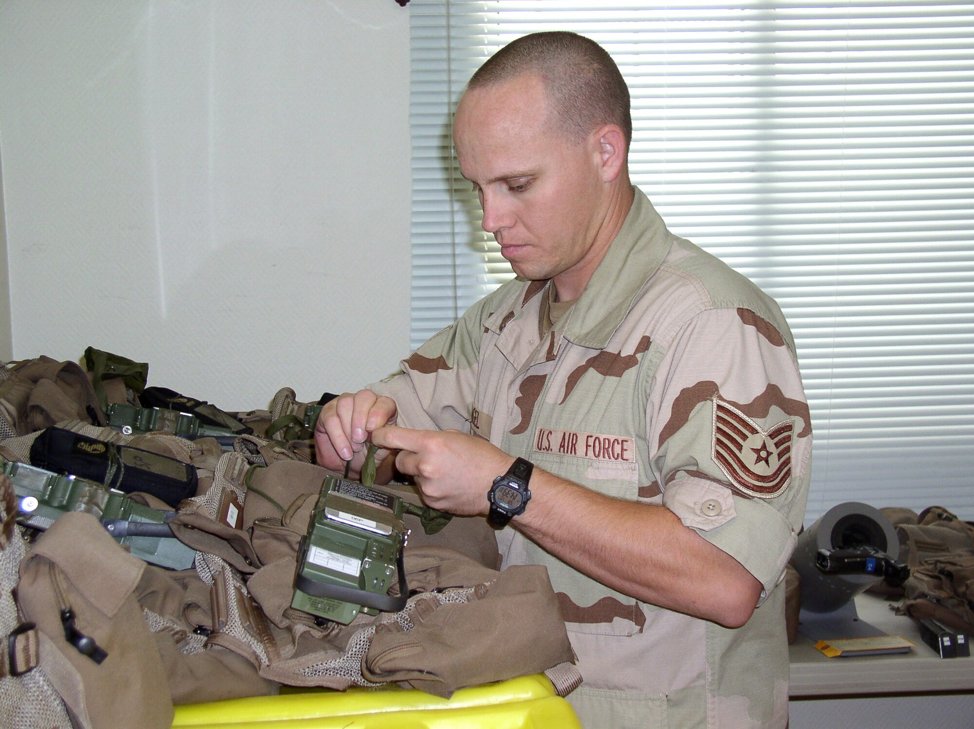 Life support specialist Tech. Sgt. Theodore Angel inspects the survival vest for one of his aircrew members in preparation for a combat mission on Saturday, July 1. Sergeant Angel, assigned to Seymour Johnson Air Force Base, N.C., is deployed to the 335th Expeditionary Fighter Squadron in Southwest Asia. (U.S. Air Force photo/Master Sgt. Dutch DeGroot)