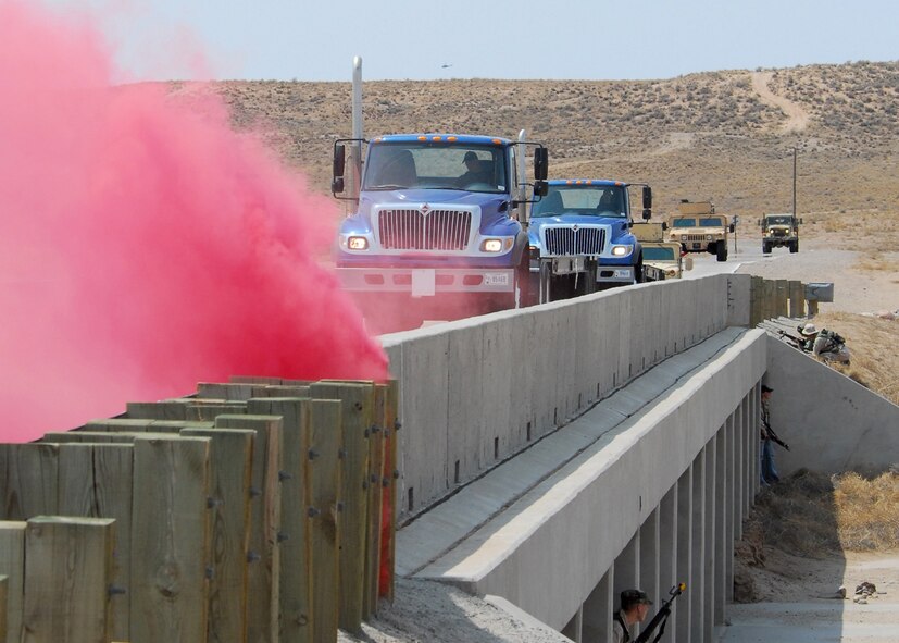 KIRTLAND AIR FORCE BASE, N.M. — During the exercise, the security forces squadron used MILES equipment and simunitions, which are detergent-based simulated rounds that are used for training.  A convoy prepares to roll over a bridge where the Operation Force Team, a team of volunteers from Kirtland who participate in exercises on base, waits to "ambush" it.  (Air Force photos by Todd Berenger)
