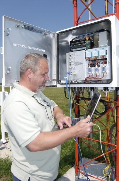 WRIGHT-PATTERSON AIR FORCE BASE, Ohio — Jim Raison, an electronics technician with the 88th Operations Support Squadron, uses a computer to run a diagnostic check of the FMQ-19 on the north end of the runway June 27. (Air Force photo by Spencer P. Lane)