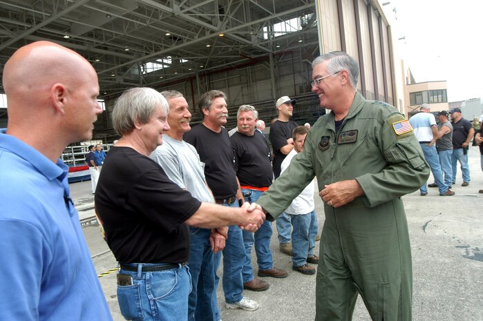 ROBINS AIR FORCE BASE, Ga. — Robert Hall and other C-130 aircraft workers, get a handshake and thanks from Lt. Gen. Mike Wooley at the C-130 rollout ceremony June 28. The first-of-its-kind MC-130W was presented to General Wooley, AFSOC commander, in a ceremony here. (Air Force photo by Sue Sapp)      