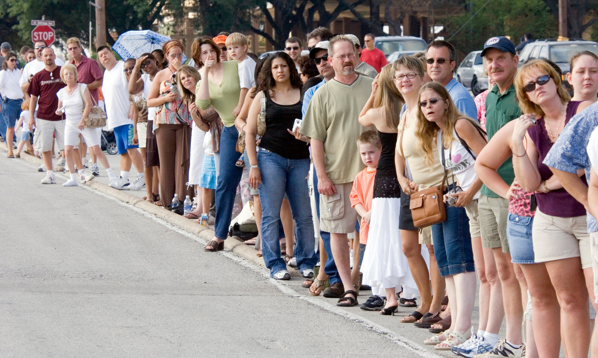 Friends and family members of those completing Air Force Basic Military Training anxiously wait in anticipation of seeing the Airmen during the 2.5-mile Airmen's run Thursday, June 29. The run is a victory celebration of the challenges overcome and esprit de corps gained by Airmen during training. (U.S. Air Force Photo/ Master Sgt. Jack Braden)