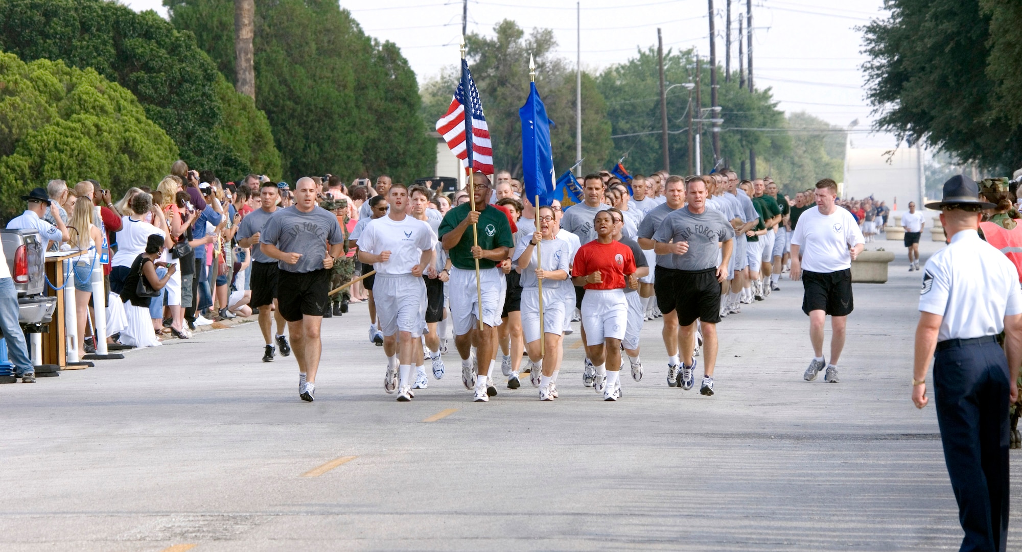 Airmen completing Air Force Basic Military Training at Lackland Air Force Base, Texas, pass family and friends during the 2.5-mile Airmen's run Thursday, June 29. The run is a victory celebration of the challenges overcome and esprit de corps gained by Airmen during training. (U.S. Air Force Photo/ Master Sgt. Jack Braden)