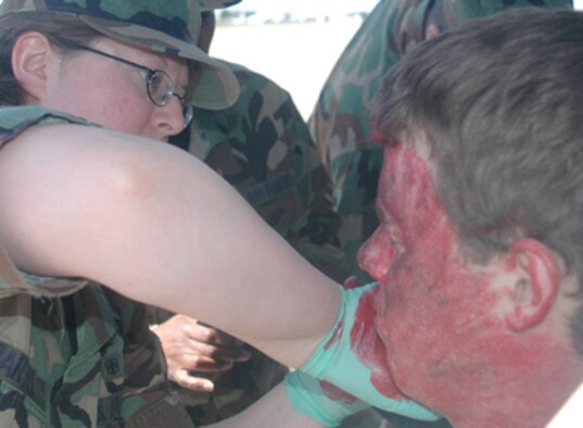GRISSOM AIR RESERVE BASE, Ind-- Tech. Sgt. Alicia Bartel, 434th Aerospace Medicine Squadron, applies moulage to the face of a person playing the role of an accident victim during an off-base major accident response exercise. Grissom teamed with local emergency management officials and first responders to exercise what would happen in the event of a major accident involving a military aircraft.  (U.S. Air Force photo/ Tech. Sgt. Doug Hays)